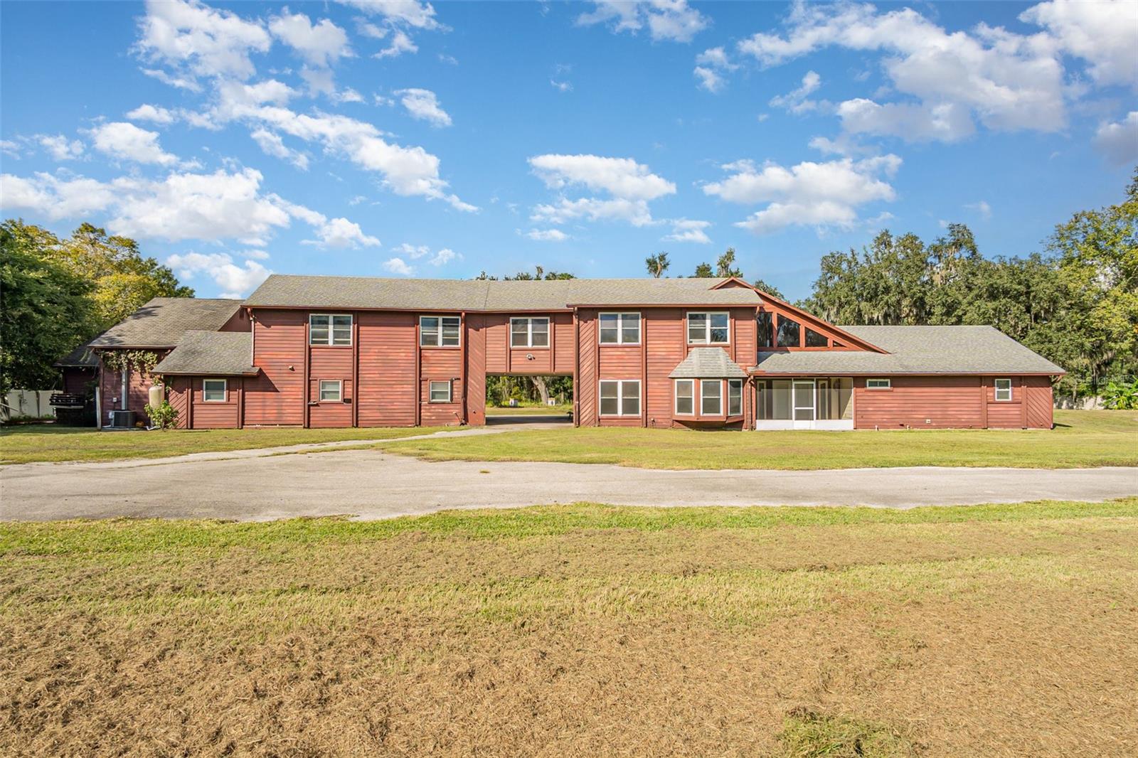 AMASSING FLIP OPPORTUNITY – call for ALL INVESTORS! Seller is OFFERING $50K IN REPAIRS CREDIT at closing for a new roof, AC, pool and / or any other repairs. SPRAWLING 3.5-ACRE Property with Endless Potential in a Private Area of Sanford! Welcome to a truly unique 5-bedroom, 4-bathroom real estate—perfect for MULTI-GENERATIONAL LIVING, INVESTMENT potential, or your DREAM RENOVATION PROJECT. Nestled in a secluded, serene area, this rare gem offers unparalleled space, privacy, and versatility. Enjoy the benefits of a FLIP HOME with MASSIVE POTENTIAL! Highlights include: A SCREENED-IN POOL—ideal for Florida living, a 2-CAR GARAGE for your vehicles or workshop needs, an unusual and flexible layout with TWO KITCHENS—perfect for separate living quarters or entertaining, a dedicated MUSIC STUDIO for creatives or content creators, and an ample land and layout space to build a guest house, apartment, or PROFITABLE VRBO SUITE. First, step into spacious, modern living with an open floor plan in the first building on the left! This thoughtfully designed section of the home features 1 bedroom, a versatile office space, and 2 full bathrooms. Enjoy seamless flow between the kitchen, dining, and living areas—perfect for both relaxing and entertaining. A large picture window opens directly onto the pool deck, bringing in NATURAL LIGHT and offering effortless indoor-outdoor living. Upstairs, you will enjoy your own private retreat — a beautifully SECLUDED WING that bridges the main residence and the second structure. Here, you’ll find two spacious rooms, a full bathroom, and a versatile loft-style area perfect for a MEDIA LOUNGE, CREATIVE STUDIO, or relaxed living space. With easy access to both sides of the property, this elevated haven offers the perfect balance of connection and privacy — ideal for guests, family, or your personal escape. The right-side building (upstairs) features a completely private, SELF-CONTAINED APARTMENT—ideal for guests, rental income, or multigenerational living. It includes two spacious bedrooms, a full bathroom, and a FULLY EQUIPPED KITCHEN that has been recently updated for modern comfort and style. For added convenience and privacy, the unit offers its own separate entrance, along with direct access to the outdoor patio and stairway. BONUS INCOME POTENTIAL! On the first floor of the right side of the building, you'll find a spacious 2-car garage, a versatile studio room, and an OVERSIZED AREA that was already being prepared by the owners to be converted into an ADDITIONAL LIVING SPACE—perfect for GENERATING EXTRA INCOME as a vacation rental or long-term VBRO unit. Plus, with three HVAC systems in place (two currently operational), you're already set up for flexible climate control throughout the property. Experience the lifestyle you’ve been dreaming of—this FLIP HOME offers not only comfort and style when all renovated, but also unbeatable access to some of CENTRAL FLORIDA’S best amenities. Enjoy world-class golf courses, scenic recreational trails, and beautiful beaches just a short drive away. Located in sought-after Seminole County, known for its top-rated schools, you’ll also be moments from upscale dining, boutique shopping, and convenient access to I-4 and the 429/417 beltways. Live, play, and thrive—WELCOME HOME TO SANFORD!