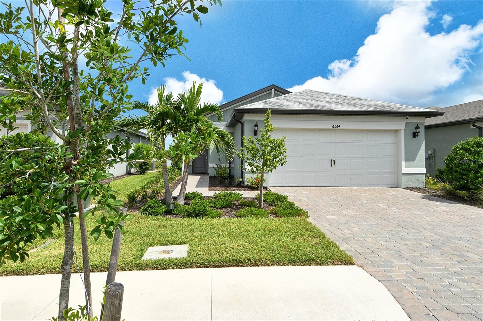 From the minute you walk into this newly built home you will be amazed by the beautiful and peaceful lake views and private lot. There is natural light throughout with the lake in sight. This home offers a spacious heart of the home open floor plan with comfort, style and upgrades. The kitchen is a wonderful size with room for a dining table and island. The chef-inspired kitchen is equipped with stainless steel appliances, great counter space and pantry—ideal for cooking, hosting or casual dining. Right outside the kitchen is a tranquil and large 20x30 lanai with portrait no-see-um screening and unobstructed views. Here you can enjoy morning coffee, grilling and very beautiful sunsets. The laundry room has the plumbing done for a utility sink and also room for cabinets. The primary bedroom comes with outstanding lake views, and an ensuite bath and walk-in closet. The 2nd and 3rd bedrooms are in the front of the home and share a nicely sized bathroom and have great closet space. There is no carpet, just sleek flooring complemented by plantation shutters and dimmable lighting throughout to create the perfect ambiance for any moment. New light fixtures inside and out have added wonderful style. The home was built with impact-resistant windows and doors for peace of mind. Gutters were installed around the whole home along with an alarm system. The house is a smart ready home, also. The garage is a 2-car garage (20x20). The original transferrable builder's warranty is in place for your peace of mind. Avanti at Waterside is one of Lakewood Ranch's most desirable communities with a low HOA fee. You are just minutes to Waterside with all the wonderful dining, shopping, weekly farmer's markets, Ranch Nites and community events year-round. It is also a short drive to UTC mall, Lido and Siesta Key beaches, downtown Sarasota and Sarasota-Bradenton International Airport. This home can be sold FURNISHED. Schedule your private showing today!