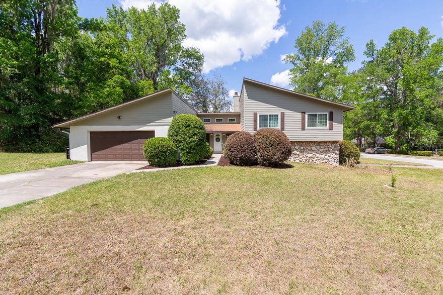 Welcome to this beautifully updated and incredibly versatile home located in the sought-after Hamilton Heights community, just off Newberry Road in the heart of Gainesville. Perfectly positioned on a spacious .38-acre lot, this property offers the ideal combination of comfort, functionality, and flexibility for today’s lifestyle.

The main level of the home features 3 generously sized bedrooms and 2 full bathrooms, thoughtfully laid out to provide both privacy and flow. From the moment you step inside, you’ll notice the extensive updates throughout, including stylish new flooring, modern fixtures, updated appliances, and tastefully remodeled bathrooms. The kitchen is designed with both everyday living and entertaining in mind, offering a cozy eat-in area for casual meals along with a separate dining room that seamlessly connects to the main living space.

The living room is truly the centerpiece of the home, featuring soaring high ceilings that create an open, airy feel, while a centrally located fireplace adds warmth and character. This inviting space is perfect for relaxing evenings or hosting gatherings with family and friends.

One of the standout features of this property is the fully functional lower level, offering approximately 864 square feet of additional living space. Complete with its own kitchenette, living room, full bathroom, and private bedroom, this area is ideal for multi-generational living, accommodating guests, or even creating a potential income-producing rental setup. The flexibility this space provides is a rare find and adds significant value to the home.

Outside, the property continues to impress with a large, fully fenced backyard—perfect for pets, outdoor entertaining, or simply enjoying the Florida sunshine. The expansive lot offers plenty of room to create your own outdoor oasis, whether that’s adding a pool, garden, or play area.

Additional highlights include a spacious 2-car garage, ample storage, and a location that places you just minutes from shopping, dining, schools, and all that Gainesville has to offer.

This home truly checks all the boxes—updated, spacious, and adaptable—making it a must-see for anyone looking for a property that can grow with their needs.
