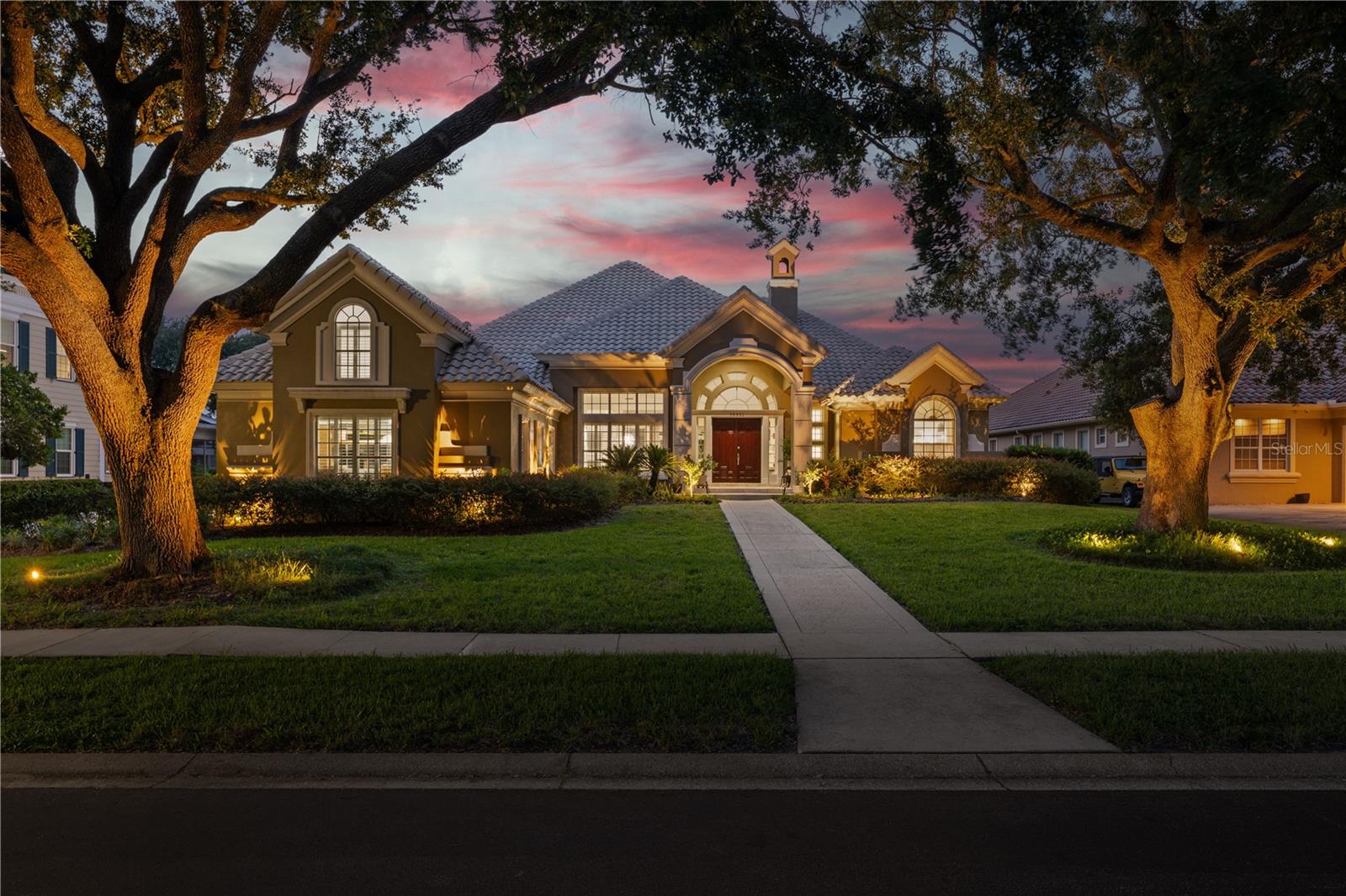Step into refined elegance in this masterfully renovated estate set within the exclusive guard-gated community of Turtle Creek. This exceptional residence spans nearly 5,000 square feet of curated living space and is perfectly positioned on an oversized, half-acre lot that offers a true sense of privacy. Inside, soaring ceilings and expansive windows flood the home with natural light, accentuating the rich architectural details and sophisticated finishes throughout. The open-concept floor plan flows effortlessly, anchored by a state-of-the-art chef’s kitchen featuring striking marble countertops, high-end stainless-steel appliances, custom cabinetry, and a large center island ideal for entertaining. Multiple living and dining areas provide flexibility for both intimate gatherings and hosting. The luxurious primary suite serves as a private sanctuary, complete with a spa-inspired bath featuring a soaking tub, walk-in shower, dual vanities, and boutique-style closets. Additional guest suites are generously sized and thoughtfully designed for comfort and privacy. A dedicated home office adds both functionality and luxury to the layout. No detail has been overlooked, this home is enriched with bespoke upgrades including two fireplaces, custom millwork throughout, a spacious three-car garage, and refined lighting and hardware selections that elevate every room. Step outside to your own resort-style retreat, where a fully screened lanai houses a sparkling pool with water features, a spacious patio, and covered outdoor living space perfect for year-round enjoyment. Ideally located minutes from Restaurant Row, world-class golf, top-rated schools, and the area’s premier attractions, this rare offering delivers the pinnacle of Central Florida luxury living.
