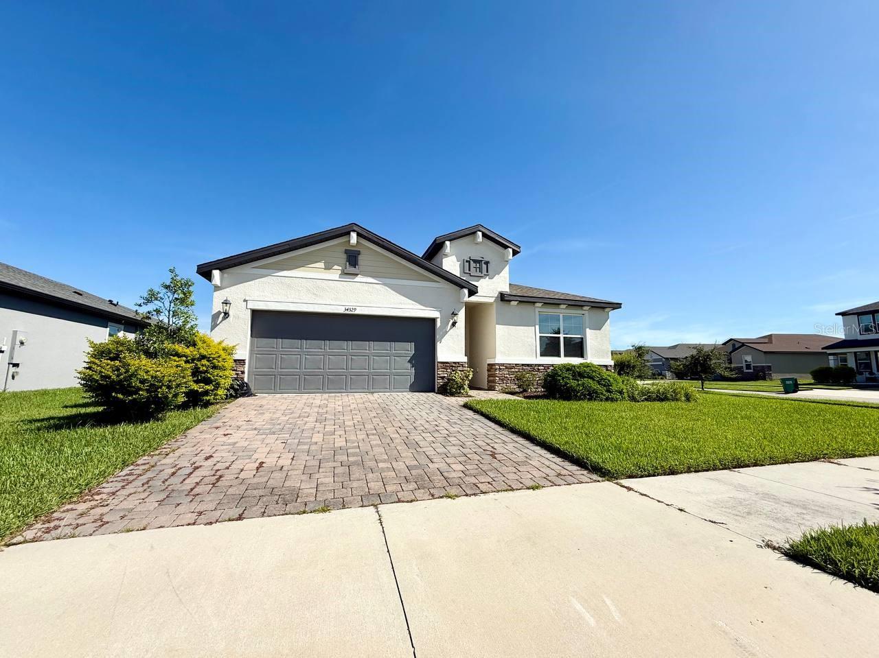 Welcome to this beautifully updated corner-lot home in the highly desirable Watergrass community of Wesley Chapel. This energy-efficient home offers 3 spacious bedrooms, 3 full bathrooms, and a versatile flex roomperfect for a home office, gym, or guest space. Designed for modern living, the home blends thoughtful updates with stylish finishes throughout. The chef-inspired kitchen is a standout feature, complete with an oversized island ideal for entertaining, built-in double ovens, a 30 Whirlpool cooktop, 42 upper cabinets, a glamorous tile backsplash, and an expansive walk-in pantry to meet all your storage needs. The owners suite is a private retreat, featuring a spa-like bathroom with a large walk-in shower and a spacious walk-in closet. Smart-home features elevate convenience, including a smart thermostat and locks, a smart garage door opener, a new water softener, and energy-efficient LED lighting throughout the home. Step outside to enjoy tranquil pond views from your backyard,or take advantage of the resort-style amenities Watergrass has to offer. Residents enjoy access to a clubhouse, multiple pools, a fitness center, tennis and basketball courts, playgrounds, and a dog park providing something for everyone. Conveniently located just minutes from I-75, Wiregrass Mall, Tampa Premium Outlets, top-rated hospitals, and excellent schools, this home truly combines comfort, luxury, and an unbeatable location. Schedule your private showing today and experience all that this exceptional home has to offer. In addition to the advertised base rent, all residents are enrolled in the Resident Benefits Package (RBP) for $50.00/month which includes HVAC air filter delivery, credit building to help boost your credit score with timely rent payments, utility concierge service making utility connection a breeze during your move-in, and much more! More details upon application. One pet welcome, 75 lb max. Vacant and Available now!