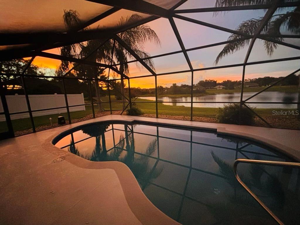 FEEL LIKE YOU ARE ON VACATION EVERYDAY as you ENJOY SPECTACULAR WATERFRONT and POOL VIEWS in this ABSOLUTELY STUNNING, BEAUTIFULLY RENOVATED 3/2 +DEN, BLOCK and STUCCO HOME situated on an OVERSIZED one-third acre PRIVATE LOT in the Fairways of Rolling Hills community! NO BOND! ROOF and HVAC (2022) - JUST MINUTES to all of the CONVENIENCES of 466A, 466 and nightly entertainment, dining, and shopping of THE VILLAGES! Elegantly etched DOUBLE ENTRY DOORS welcome you into the foyer of this MAGNIFICENT home. From the moment you arrive, you’ll be CAPTIVATED by the BREATHTAKING WATERFRONT and POOL VIEWS! This INCREDIBLE OUTDOOR OASIS offers ABUNDANT PRIVACY with fencing along each side property line. The covered lanai features a lovely dining area and a GENEROUS sitting space with SLIDING PANELS. There’s also an above ground HOT TUB! - perfect for unwinding after a long day! If you’ve been dreaming of RESORT-STYLE LIVING AT HOME—THIS IS IT! Dive into the refreshing POOL, soak up the sun on the deck, lounge in the hammock with your favorite book, or simply sit and enjoy the SURROUNDING VIEWS and peaceful bird sanctuary! The interior of this EXQUISITE home features an EXPANSIVE OPEN LAYOUT with SOARING 15’ VAULTED ceilings in the main living area. GORGEOUS HICKORY FLOORING flows seamlessly THROUGHOUT enhancing the home’s beauty and style. The SPACIOUS living room features TRIPLE POCKET SLIDING GLASS DOORS that open to the FABULOUS POOL area and a CUSTOM-BUILT SHIPLAP entertainment wall enhanced with a cozy electric FIREPLACE and beautiful hickory mantel. A modern dining room with double windows, and striking chandelier provide a lovely space for entertaining. The EXCEPTIONAL kitchen boasts staggered cabinetry with CUSTOMIZED UP-LIT display boxes; MODERN VEINED QUARTZ countertops; TILE backsplashes; STAINLESS appliances; a SHIPLAP accent wall with CUSTOM WOOD SHELVES; above and under CABINET LIGHTING; COUNTER-HEIGHT, EAT-IN breakfast bar; closet PANTRY; and an ADDITIONAL PANTRY closet just off of the kitchen. The adjacent dinette nook area features a CUSTOM-BUILT u-shaped bench with STORAGE and three windows overlooking the PICTURESQUE WATER and POOL. RETREAT to the ELEGANT primary bedroom boasting HIGH VAULTED ceilings, GENEROUS WALK-IN closet, and CONVENIENT SLIDING DOORS leading to the pool and lanai area. Its LUXURIOUS en-suite bathroom boasts TWO striking vanities with oval mirrors and modern lighting; large soaking TUB with shiplap and TILE accents; TILED, WALK-IN, ROMAN-STYLE shower; SEPARATE water closet; and a LINEN closet. A SPLIT FLOOR PLAN, with two additional bedrooms and a second bathroom, ensures plenty of PRIVACY for guests. Near the front of the home, there's also an ADDITIONAL CUSTOMIZED DEN/OFFICE featuring a double desk, built-in drawers, filing cabinets, book shelves, and floating wall shelves. The centrally located, INTERIOR LAUNDRY room offers white shaker cabinetry for EXTRA STORAGE and a utility sink. The SIDE-ENTRY garage features STORAGE cabinets with a built-in WORKBENCH/tool area, attic access, and painted floor. TOO MANY UPGRADES TO MENTION!!! DON’T MISS YOUR OPPORTUNITY to make this EXCEPTIONAL WATERFRONT POOL HOME YOUR OWN! The Fairways of Rolling Hills is conveniently located JUST MINUTES from The Villages, 466A, 301, and 466 with an ABUNDANCE of shopping, restaurants, banks, medical and more! PLEASE WATCH OUR VIDEO of this EXQUISITE HOME and CALL TODAY to schedule your Private Showing or Virtual Tour!