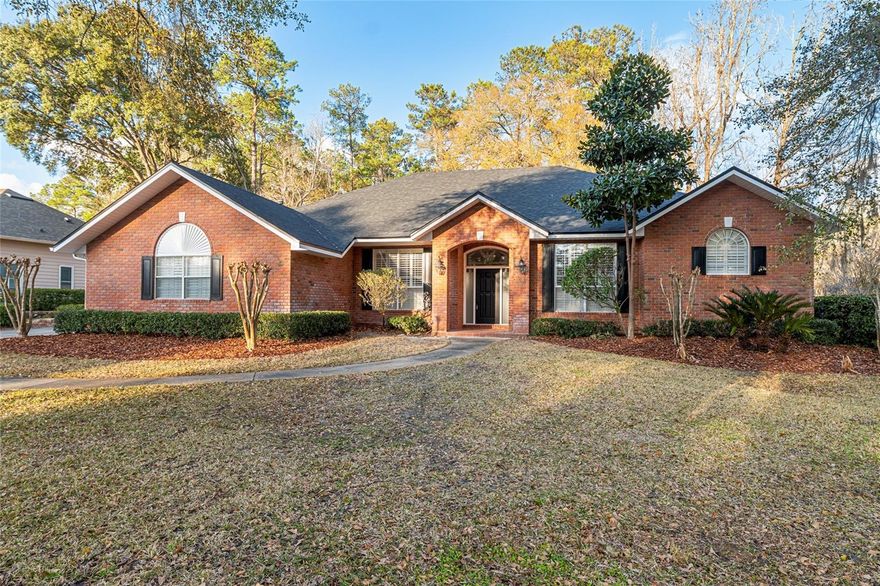 One or more photo(s) has been virtually staged. Welcome home to this beautifully maintained residence nestled in the desirable Turkey Creek subdivision located outside of the City Alachua in NW Gainesville, situated on a private .47-acre lot. This inviting home features a classic traditional front elevation accented with timeless red brick on the front with black shutters, offering curb appeal that feels both warm and enduring. Inside, you’ll find a thoughtfully designed split floor plan ideal for both everyday living and hosting guests. Two guest bedrooms are conveniently located off the family room, while a third guest bedroom with a closet and full bath across the hall offers the flexibility to serve as a home office or additional private suite. The spacious primary bedroom is a true retreat, complete with two walk-in closets and a well-appointed en suite bath. A bright and airy 331 SF Florida room (not included in the heated and cooled SF) is accessible from the family room, living room, hallway bath, and primary bedroom, creating the perfect space to relax, entertain, or enjoy views of the private backyard year-round. Additional highlights include tile and wood flooring throughout (no carpet), a separate formal living room adjacent from the formal dining room, and a fresh, modern feel thanks to the entire home being recently repainted in neutral tones inside and out, including all doors, trim, crown molding, closets, and the two-car garage door. Major updates provide peace of mind, with a new architectural roof installed in 2021 and HVAC replaced in 2019. This home offers comfort, flexibility, and privacy in a well-established neighborhood—an exceptional opportunity for you to call home. Seller offering a $3,000 credit toward appliances including the dishwasher and refrigerator with an acceptable offer.