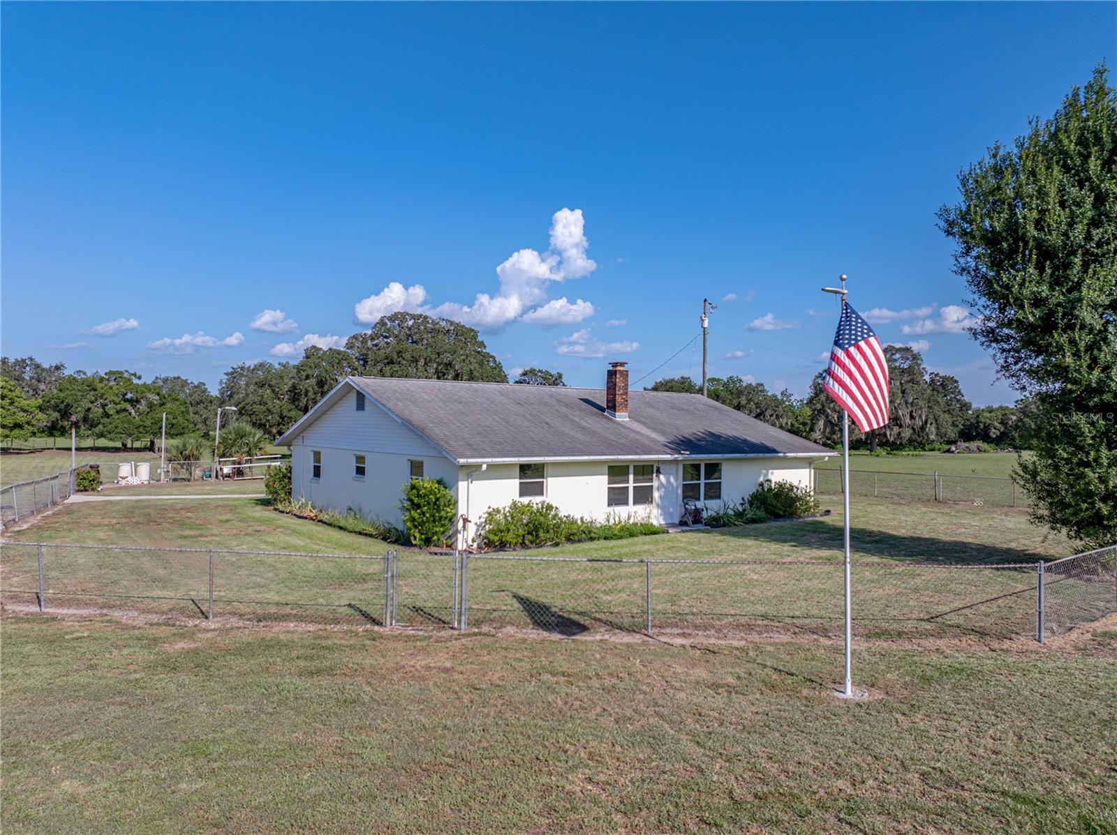 Lake Wales Ridge Outdoor Paradise with Ranch-Style Comfort on 16+ Acres!
If you’re seeking wide-open space, peaceful surroundings, and the charm of country living without sacrificing convenience—this is your dream property! Nestled on over 16 acres of scenic pasture land dotted with majestic oak trees, this well-maintained ranch-style home offers the perfect blend of natural beauty and everyday comfort.
Surrounded by agricultural land and conservation property, you’ll enjoy serene views, abundant wildlife, and endless opportunities for outdoor adventure—yet you're still just minutes from shopping and local amenities.
The 1,872 sq ft home features a thoughtfully designed split-bedroom floor plan with 3 bedrooms and 2 full bathrooms. At its heart is a cozy living room anchored by a beautiful stone fireplace—perfect for gathering. A spacious fully equipped kitchen offers wood cabinetry and solid surface countertops and loads of storage, with a dining room conveniently located nearby and an interior laundry room with extra cabinets. Kick back and unwind on the spacious screened back porch that overlooks your own private pasture—ideal for relaxing evenings or watching the sunrise with a cup of coffee.
Additional improvements include 2 storage/workshop buildings and 2 pole barns all equipped with power and water so you can bring all your equipment & toys.
Recent updates include a include a whole home generator and new HVAC in 2023
Whether you're a rancher, equestrian, farmer, or just someone who loves nature and privacy, this unique property offers room to roam and a lifestyle that’s hard to match.