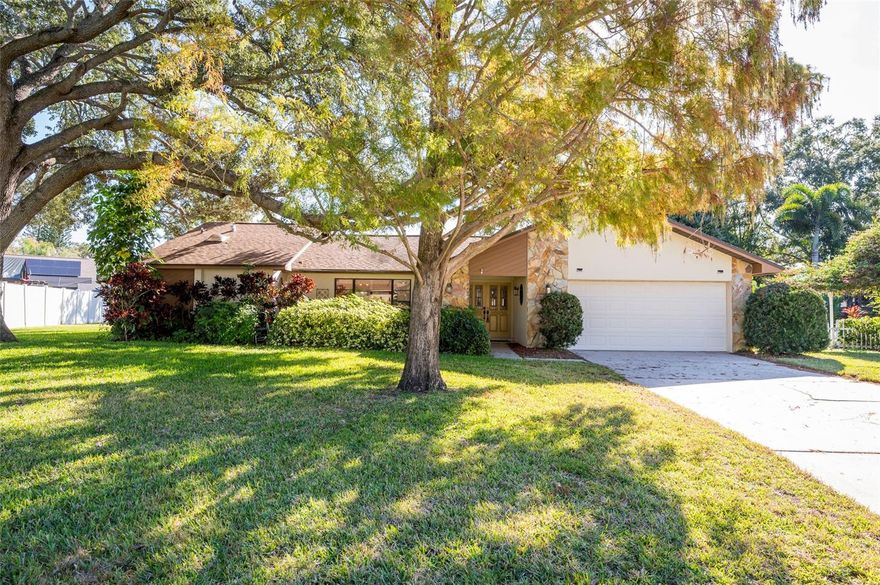 This beautifully laid-out Clearwater home offers a comfortable mix of indoor space, outdoor living, and a location that’s easy to enjoy year-round! Wood flooring runs throughout the main living areas, which include a cozy living room and a separate formal dining room. The kitchen is functional and social, with room for a breakfast nook and a fireplace sitting area featuring vaulted ceilings and skylights. A pass-through window opens to the pool deck, making it easy to bring in fresh air or serve food outside. The screened pool deck is partially covered and equipped with lights and fans, giving you flexible space for relaxing or entertaining year-round. Beyond the pool, the large backyard offers plenty of options—plant a food forest, build a play area, or let kids and pets spread out.
The primary bedroom includes a walk-in closet, and the primary bath features a nicely updated, wheelchair-accessible shower. The garage is spacious and practical, with a newer water heater and a Pelican whole-house water purification system. All four-point items are in good condition. Out front, mature landscaping and a covered walkway create a welcoming approach to the home. 

The home is not located in a flood zone, offering added peace of mind and lower insurance considerations. The neighborhood sits at a higher elevation and has historically remained dry during major storm events, making it a place friends and family often gathered during storms due to its relative protection from flooding and coastal wind exposure.

When you’re ready to head out, you can walk to Coachman Ridge Park and hop directly onto the Ream Wilson Clearwater Trail, which connects into the broader Pinellas Trail system. Beach days are an easy drive—about 20 minutes to Clearwater Beach, the Clearwater Aquarium, or the laid-back waterfront vibe of Safety Harbor.
This is a solid home with good bones, great outdoor space, and room to add your own finishing touches while enjoying one of Clearwater’s most convenient locations.