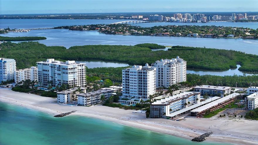 Poised high above the Gulf of Mexico in the coveted & guard-gated Orchid Beach Club, this gulf-to-bay penthouse features breathtaking direct views of azure Gulf waters & expansive Lido beach, dazzling & vibrant sunsets, plus spectacular Bay & Downtown City views. This masterfully renovated 3654 sf condominium embodies refined luxury, bespoke craftsmanship, & is offered turnkey furnished featuring new designer pieces curated by decorator Audrey Authur. Your private elevator foyer opens to an expansive main living room, where a comprehensive renovation showcases Venetian plaster walls, sculptural Soft Square lighting, and custom floating cabinetry by Metro Cabinet Company, creating an atmosphere of effortless sophistication. Floor-to-ceiling impact-rated sliding glass doors draw the eye to the shimmering horizon, ensuring the Gulf remains an ever-present backdrop for gathering and entertaining. The adjacent dining room enjoys equally dramatic views and is anchored by a bespoke floating wine bar, complemented by dining table and chairs imported from Italy.  Beyond, the serene family room offers a relaxed coastal setting—quiet, luminous, and framed by sparkling blue water, with custom finishes that evoke warmth and refinement. The kitchen blends craftsmanship and function with custom Westwood Manufacturing cabinetry, refined stone surfaces, a center island, and a suite of chef-caliber appliances including a custom paneled Sub-Zero refrigerator and Faber/Dacor cooking ensemble including double ovens & 5-burner gas cooktop.  The Gulf-facing terrace offers an extraordinary expanse of outdoor living space with a granite-clad grill station and stainless hood, ideal for coastal dining and sunset gatherings. The spacious primary suite is a private retreat with sitting area and direct access to the gulf-front terrace, offering an intimate front-row seat to sunset, and the rhythm of the waves. Two custom walk-in closets and a spa-inspired marble bath with a dual-entry glass shower and deep jetted soaking tub complete this serene escape. Two guest suites welcome visitors with bespoke walk-in closets, luxuriously finished baths, and access to a 2nd sweeping terrace capturing enchanting sunrises and views of Sarasota Bay & the sparkling city skyline. Each bedroom is finished with warm wide-plank Legno Bastone floors. Thoughtful updates throughout include Control4 smart home automation w/ LED lighting & electric window treatments, frame art TV, custom window cornices, designer wallpaper, wide-plank wood floors, a reimagined laundry room, and 2025 ACs. A rare private 3-car garage completes this remarkable offering. Life at Orchid Beach Club is defined by indulgent amenities, attentive service, and private beachfront living. Residents enjoy concierge services, on-site management, modern fitness center, massage room, library, game room, beautifully designed club spaces with fireside lounge, terrace, catering kitchen, heated Gulf-front pool & spa, & summer kitchen. Additional pluses include 24-hr guard-gated security, electric vehicle charging stations, bicycle & kayak storage, & 2 well-appointed West Indies–style guest suites.  Lido Key offers miles of soft white sand, turquoise water, & lush parkland while nearby St. Armands Circle & downtown Sarasota offer exceptional dining, boutiques, & cultural experiences. Make this exceptional sanctuary yours, a unparalleled lifestyle for the discerning buyer seeking the pinnacle of Gulf-front living.