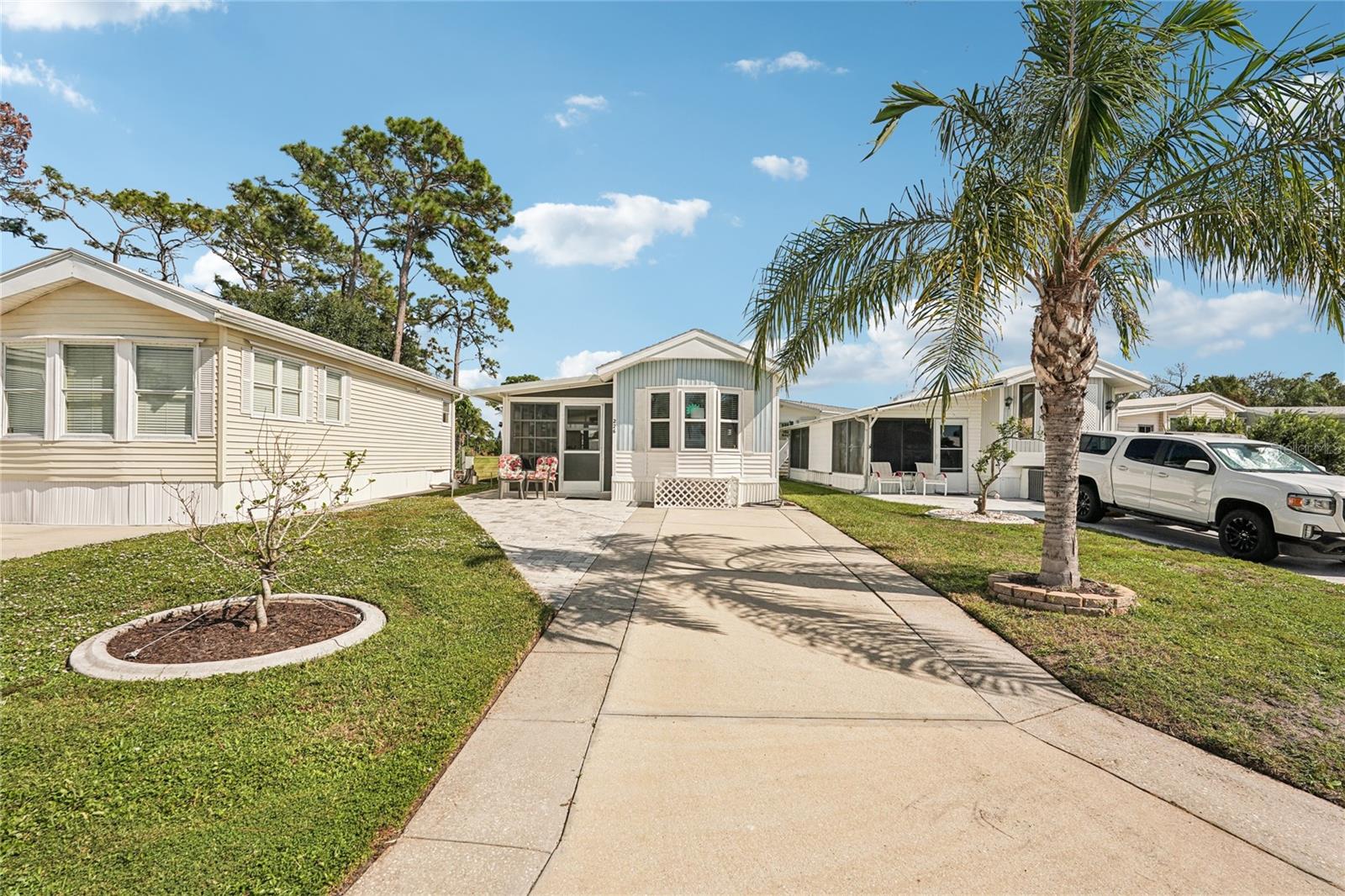 This fully remodeled and furnished 1-bedroom, 1-bathroom manufactured home is a fantastic opportunity for a second home, or permanent residence! Located in the gated 55+ community of Kings Gate Park, it is just 3 miles from Nokomis Beach! Situated on one of the highest elevations in the park and outside of a flood zone, the property includes land ownership and a low monthly HOA fee that covers cable, internet, water, sewer, and lawn care. Inside, this beach cottage-inspired retreat has been updated from top to bottom. Brand-new vinyl flooring runs throughout, complemented by modern window treatments, new front and back windows, solid wood cabinets in the kitchen, and updated electrical. The plumbing has been completely re-piped, and a new hot water tank ensures worry-free living. No polybutylene grey pipes! The beautifully updated bathroom features a walk-in shower with a sleek quartz countertop vanity, while the lanai, complete with new screens, extends your living space. For added convenience, the enclosed laundry area includes a new stackable washer and dryer. Outside, enjoy the privacy of a large green space beyond the newly installed paver patio—perfect for relaxing or entertaining. The spacious driveway provides ample parking for you and your guests. Beyond your home, Kings Gate Park offers an array of amenities to enrich your lifestyle, including a private boat ramp, RV and boat storage, a sparkling community pool, and courts for pickleball, tennis, and shuffleboard. With its prime location near pristine Gulf beaches, meticulous updates, and a vibrant community setting, this home offers the best of Florida living.