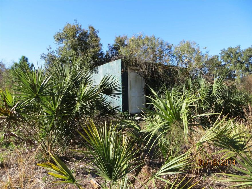 Great investment opportunity with this 2.5 acre vacant lot. Features a 2 story block hut w/metal roof, and masonry and stone fireplace, bathroom with shower. Water tank on roof for pressure and warm water, septic tank and well, hook up a generator and you are good to go!  Also features an all concrete shed/safe room in back with concrete roof. Raised concrete slab for animal/hog pen. Beautiful set up! Hunting and off road trails all around. Perfect for hunting or riding land. With some work, this property can be lived in or rented. Nice and private, but also surrounded by other established properties! Perfect land to buy and hold! Power and development is already in the works across the street. You will not want to miss out on this rare opportunity!