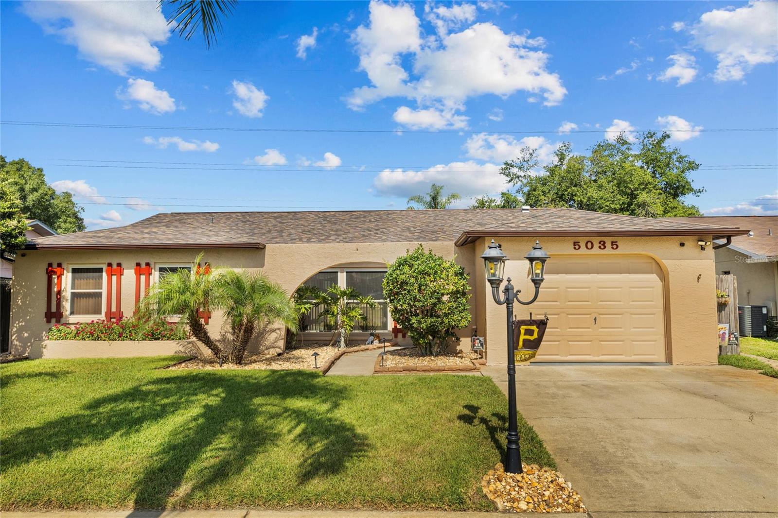 This impeccably maintained home offers four spacious bedrooms and two bathrooms. The primary bathroom features a walk-in shower. The home boasts an open kitchen/family room combo and a spacious living room, both filled with natural light and ceiling fans throughout. There's plenty of storage, and an oversized garage adds extra convenience. The design creates a seamless flow between indoor and outdoor living spaces, perfect for both everyday living and special occasions. French doors lead to an enclosed rear patio and a heated 14x28 pool with an automatic cleaner. Whether you're enjoying your morning coffee or hosting a casual gathering, this space is sure to become a favorite retreat. Offering year-round enjoyment regardless of the weather. Whether you're seeking a refreshing swim or a leisurely soak under the sun, this pool promises endless hours of aquatic fun for the whole family. Enjoy easy access to shopping, dining, and entertainment options, as well as major highways for convenient commuting. With the Gulf of Mexico, Tarpon Springs Sponge Docks just a short drive away, outdoor adventures and beach days are always within reach. Don't miss out on the opportunity to own this exceptional property. Schedule your private tour today!
A/C 2024, Roof 2018, Water Heater 2018 and Hurricane Windows are less than 10 years old