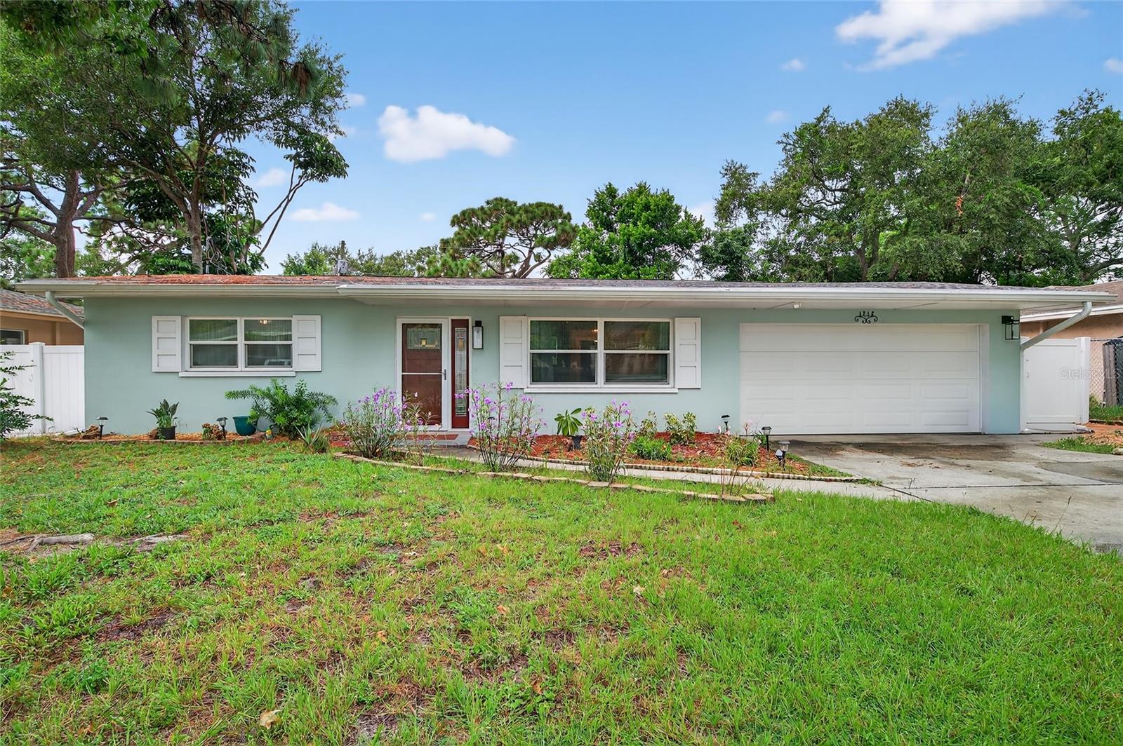 Move-in Ready Clearwater Home with Designer Touches & Prime Location! This beautifully updated single-family home offers the perfect blend of style, comfort, and convenience. The heart of the home is the designer custom kitchen featuring blue cabinetry, coordinating backsplash, granite countertops, and stainless steel appliances. Peace of mind comes with major upgrades throughout: hurricane-impact windows, a new roof (2024), newer A/C (2022), hot water tank (2016), new front and garage door, air ducts replaced, and seamless gutters with a leaf guard system. Inside, matching tile flooring flows seamlessly from room to room. The guest bathroom has been completely remodeled, including updated plumbing. The versatile 4th bedroom is ideal as a home office or nursery located just off the primary suite. Step outside to enjoy Florida living at its best! The pool-sized backyard with a spacious deck and 10x10 shed with loft is perfect for a workshop, hobby space, or kids’ playhouse. Outdoor maintenance is simplified with neatly trimmed landscaping, a newly installed Orbit sprinkler system, and low-maintenance vinyl fencing. Home is just 6 miles to the world-famous sugary sands of Clearwater Beach and 3 miles to vibrant Downtown Dunedin. Everyday essentials—grocery stores, pharmacies, and restaurants—are minutes away. This home is zoned for Dunedin Middle and Dunedin High, both magnet schools, making it a great choice for families seeking quality education options. Best of all, it’s in a non-flood zone. Beyond the remodel updates of the past two years, and nearly $50K in recent improvements this home provides exceptional value and peace of mind for the next owner!