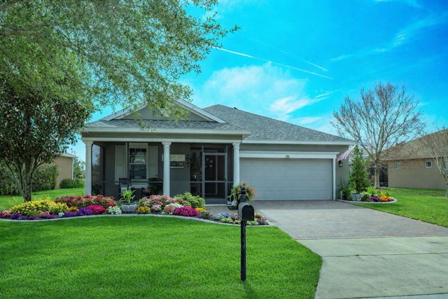 This beautifully maintained, energy-efficient home is situated on a premium lot with no rear neighbors, offering privacy and serene conservation views.  Thoughtfully updated and move-in ready, the home features a new roof installed in 2024, owner owned solar panels, and a water softener for added comfort and efficiency.  Inside, the open-concept layout is enhanced by designer details throughout, including custom built-ins, elegant crown molding, and stylish shiplap accents that add warmth and character. The modern kitchen is a true centerpiece, showcasing quartz countertops, matching appliances, under-cabinet lighting, crown-molded cabinetry, decorative hardware, pot and pan drawers, and a designer shiplap backsplash, along with a complimentary center island for additional seating and prep-space. The oversized utility/ flex room just off the kitchen provides exceptional versatility- perfect for a home office, hobby space, or exercise room.  The spacious living and dining areas flow seamlessly through triple sliding doors to the enclosed lanai, which was upgraded in 2025 with a mini-split system allowing for year-round comfort.  Step outside to discover an extensive brick-paved outdoor area, ideal for entertaining, grilling, or simply enjoying Florida living with sweeping views of nature and conservation land.  The primary suite is filled with natural light and easily accommodates oversized furniture. The ensuite bath features dual-sink vanities, a glass-enclosed tiled shower with bench seating, and a separate water closet. A private guest bedroom is thoughtfully positioned away from the primary suite and offers a built-in bookcase and easy access to a full bath with walk-in shower. An additional den/study provides flexibility for guests or quiet relaxation. Located in the highly desirable Trilogy Cascades of Groveland, a guard- gated 55+ community, residents enjoy resort-style amenities including a full-service restaurant and bar, two fitness centers, indoor and outdoor pools, spas, walking trails, dog park, tennis, pickleball, bocce and more. With over 50 clubs, live entertainment, demonstrations, and social activities, this community is designed for an active and engaging lifestyle.  HOA fees include lawn, and shrub maintenance, basic cable, internet with landline, home security monitoring, streetlights, and maintenance of the guard-gated entrance and clubhouse amenities.