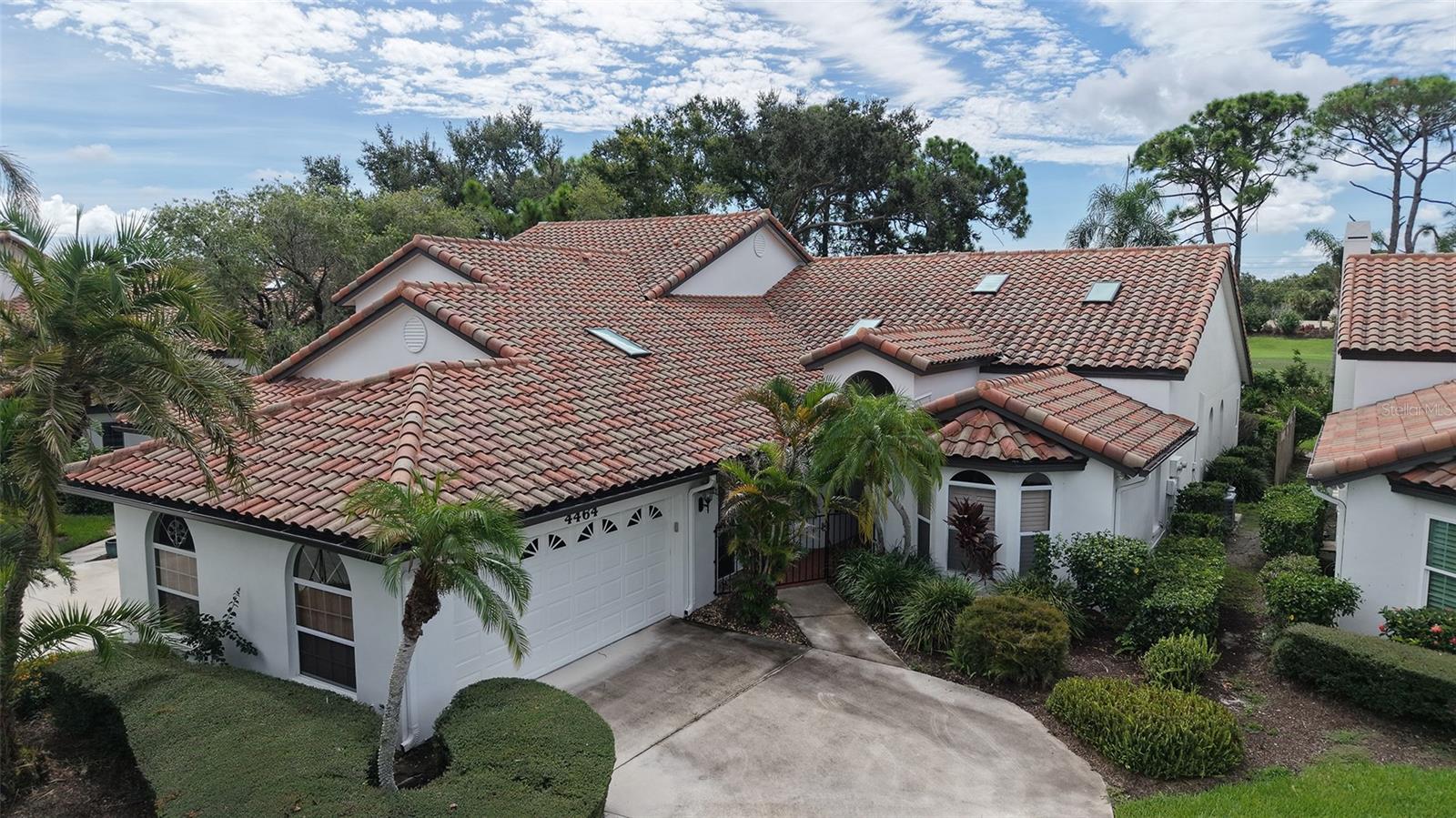 Some photos have been virtually staged. Idyllically located in Villa Palmeras at Prestancia, this spacious 2,833 sf maintenance-free villa offers soaring ceilings, skylights, and expansive windows that fill the home with natural light. A gated courtyard entry welcomes you into the open floor plan featuring a large living/dining area, eat-in kitchen with abundant cabinetry, and an enclosed 12x40 Florida room with golf and water views. The owner’s suite boasts a sitting area, walk-in closet, and spacious bath with soaking tub and separate shower. Guest bedrooms are privately situated on opposite sides of the home for comfort and privacy. Additional highlights include two new A/C units (2020), breezeway to garage, and flexible third bedroom/den with French doors. Villa Palmeras residents enjoy two heated community pools, lush landscaping, and 24/7 guard-gated security. Optional membership is available at TPC Prestancia Golf Club with two 18-hole courses, dining, and social activities. Ideally located near shopping, dining, Legacy Trail, and Siesta Key beaches.