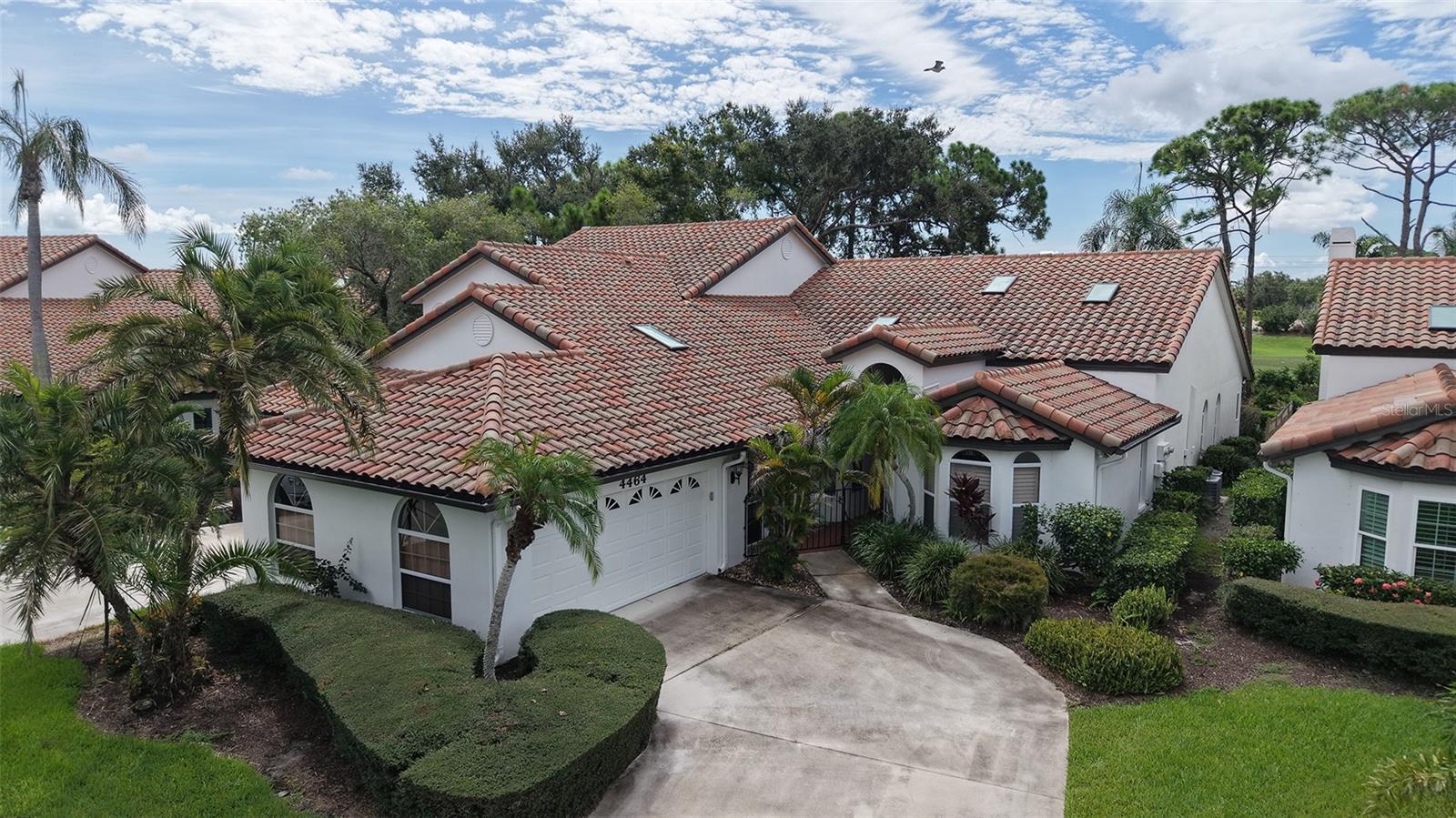 Some photos have been virtually staged. Idyllically located in Villa Palmeras at Prestancia, this spacious 2,833 sf maintenance-free villa offers soaring ceilings, skylights, and expansive windows that fill the home with natural light. A gated courtyard entry welcomes you into the open floor plan featuring a large living/dining area, eat-in kitchen with abundant cabinetry, and an enclosed 12x40 Florida room with golf and water views. The owner’s suite boasts a sitting area, walk-in closet, and spacious bath with soaking tub and separate shower. Guest bedrooms are privately situated on opposite sides of the home for comfort and privacy. Additional highlights include two new A/C units (2020), breezeway to garage, and flexible third bedroom/den with French doors. Villa Palmeras residents enjoy two heated community pools, lush landscaping, and 24/7 guard-gated security. Optional membership is available at TPC Prestancia Golf Club with two 18-hole courses, dining, and social activities. Ideally located near shopping, dining, Legacy Trail, and Siesta Key beaches.