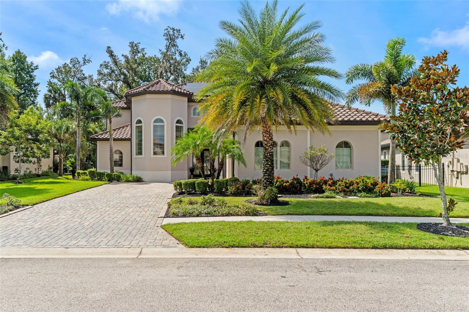 Masterful design and modern luxury are uniquely embodied in this beautiful estate, set within one of Oviedo’s most exclusive gated communities and crafted for those who value elegance, privacy, and timeless sophistication. Recently completed in 2020, this custom built architecturally striking residence features 5 bedrooms, 6 baths, and boasts over 4,000 square feet of thoughtfully curated living space. A stately brick paver driveway welcomes you to the grand entry, where soaring ceilings, a classic tile roof, and refined design details immediately set the tone. Inside, the open floorplan is accentuated by rich natural light, with designer chandeliers and sleek modern finishes that elevate everyday living and create the perfect backdrop for elegant entertaining. At the center of the home, a chef’s kitchen blends beauty and function with precision. Beautifully appointed with energy-efficient stainless steel appliances, a double oven, 42” custom cabinetry, and a walk-in butler’s pantry, this space was designed to inspire culinary creativity and effortless hosting. The kitchen flows into the expansive living and dining areas, where French doors open to an oversized screened-in lanai, offering tranquil views of the wooded backyard. With a private bath already in place and picturesque conservation views as the backdrop, this outdoor space is primed to be transformed into a resort-style sanctuary. The primary suite, located on the main floor, is a serene retreat designed with privacy in mind. It features a large custom-fitted closet and a spa-worthy bath complete with double vanities and an enormous dual shower, an ideal place to begin and end the day in complete comfort. Upstairs, secondary bedrooms offer refined accommodations, while a private balcony reveals peaceful treetop views, perfect for enjoying sunsets or a quiet moment away from it all. Additional highlights include a climate controlled three-car garage, a whole-home water softener system, and a fully paid Tesla solar energy system with backup generator, providing near net-zero electric costs and long-term peace of mind. Ideally positioned within a top-rated school district and just minutes from Oviedo on the Park, 417, UCF, and Central Florida’s world-class destinations, including Orlando International Airport, Disney, Universal Studios, and Florida’s renowned beaches, this home offers a rare opportunity to experience luxury living in one of the most sought-after addresses in Oviedo. 436 Terravista Place is the embodiment of thoughtful luxury and an extraordinary home for an extraordinary life. To experience its full beauty, schedule your private showing by appointment.