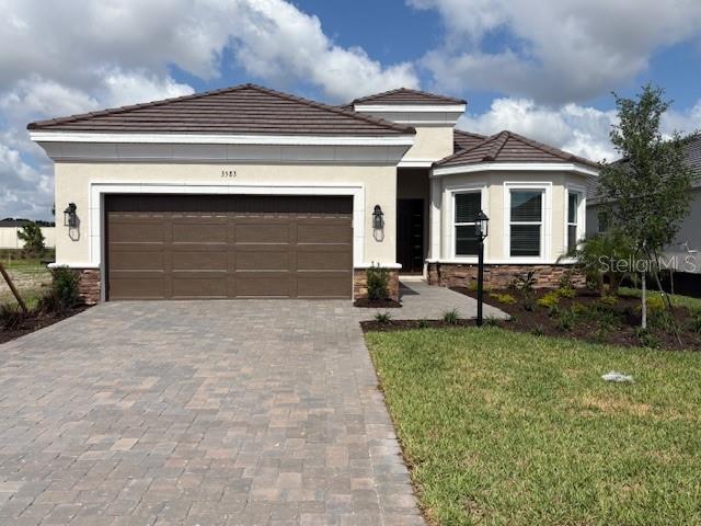 New Construction - Ready Now! Built by Taylor Morrison, America's Most Trusted Homebuilder. The Lazio at Esplanade at Azario Lakewood Ranch. Resort-Style Living at Esplanade at Azario Lakewood Ranch, the perfect blend of relaxation and recreation! Enjoy the heated resort-style pool, state-of-the-art fitness center, and energizing aerobics classes. For outdoor enthusiasts, there are pickleball courts, scenic trails, and Vitality Park. Unwind with a facial massage or by the fire pit after a workout. Exclusive amenities like a Wellness Center, Culinary Center, and sports courts ensure there's something for everyone, whether you want to stay active or relax in style. Discover the Lazio, a beautifully designed home with plenty to love. Step through the foyer, where a secondary bedroom, full bath, and private study sit to one side, while another secondary bedroom, full bath, laundry room, and garage entry are on the other. The designer kitchen, featuring a spacious island, flows seamlessly into the casual dining area, formal dining space, and gathering room. From here, step onto the expansive lanai, perfect for outdoor living. The primary suite is tucked at the back of the home and offers a spa-like bath with dual sinks, a large shower, a private water closet, and a generous walk-in closet. Structural options added include: Gourmet kitchen, extended casual dining, study with double doors, bay window at primary suite, 10' ceilings, tray ceiling package at primary suite and gathering room, 8' interior doors, extended outdoor lanai, outdoor kitchen rough-in, pool and spa prewire, and tandem garage. Photos are for representative purposes only. MLS#TB8354263