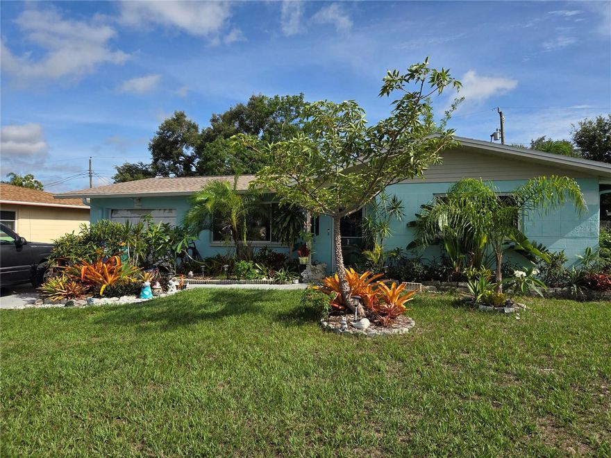 Live in a home with character. Your plant lover’s dream. Solid block home with a new roof in 2025 and a newer AC. Porcelain tile in living room, dining room and kitchen. Tiled Florida room off the dining room, great for an office or even an extra bedroom. Back screened in patio great for enjoying our Florida evenings with a glass of wine. Put your grill on the slabbed side yard and enjoy a good steak. Let’s talk about the back yard. Escape to your own private island, lush with landscaping that needs some TLC to bring it back to life. This sweet home is located in Seminole, minutes to Seminole Lake and Park and 10 minutes to the beaches.