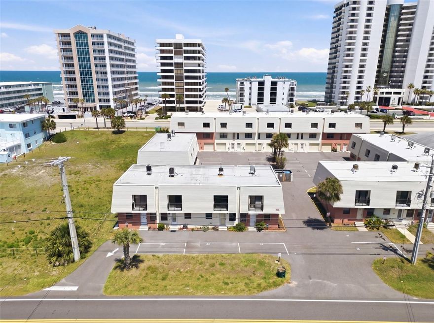 Live the vacation lifestyle every day. This updated 2-bedroom, 2.5-bath condo just steps from the beach offers the perfect layout with two private ensuite bedrooms upstairs plus a convenient guest half bath downstairs. Whether you're looking for a coastal getaway, full-time residence, or income-producing investment, this move-in-ready home checks all the boxes. Inside, you'll find luxury vinyl plank flooring throughout the main living area, an updated kitchen with stainless steel appliances and a stylish tile backsplash, and in-unit laundry with a full-size washer and dryer on the first floor. All bathrooms have been elegantly updated with glass tile accents, adding a modern coastal touch. Additional upgrades include newer windows and sliding glass door and new AC for peace of mind. Enjoy the convenience of one designated parking space plus guest parking, and the unbeatable location beachside!
