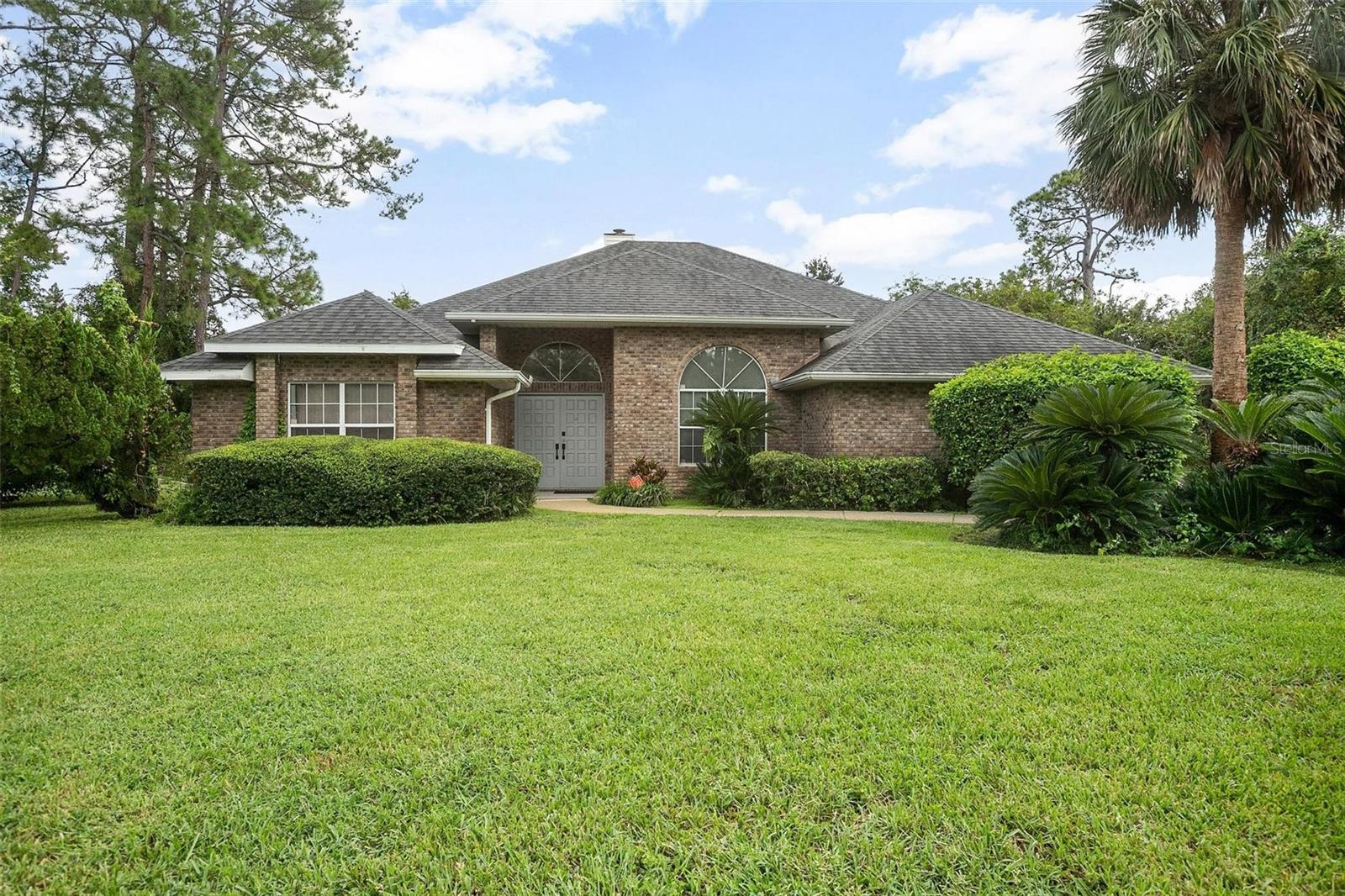 One or more photo(s) has been virtually staged. Spacious 4-Bedroom Brick Home in Indigo Lakes
Welcome to this beautiful 4-bedroom, 3 bath brick home tucked away at the end of a quiet cul-de-sac in the highly desirable Indigo Lakes community. Offering comfort, convenience, and charm, this home is perfect for the families or those who love to entertain. Enjoy a functional kitchen designed with practicability in mind, featuring a built-in desk, generous cabinetry, plenty of counter space, and numerous draws and mini cabinets for easy organization. Home is equipped with 2 HVAC systems, one dedicated to the master suite and the other serving the main house and guest bedrooms. No heat pump.Generous bedrooms, 3 with En-suite bathrooms, providing privacy and flexibility for family and guests. Freshly updated flooring and brand new carpet for a modern, move-in-ready feel. Enjoy 2 cozy living spaces, sharing a wood burning fireplace, creating warmth and ambiance throughout the home. Abundant closet space in bedrooms, baths and kitchen. Relax on the large screened porch overlooking the well landscaped backyard. Easy access to Daytona Beach, shopping malls, the Daytona Speedway, and Daytona International airport along with I-95 and I-4.