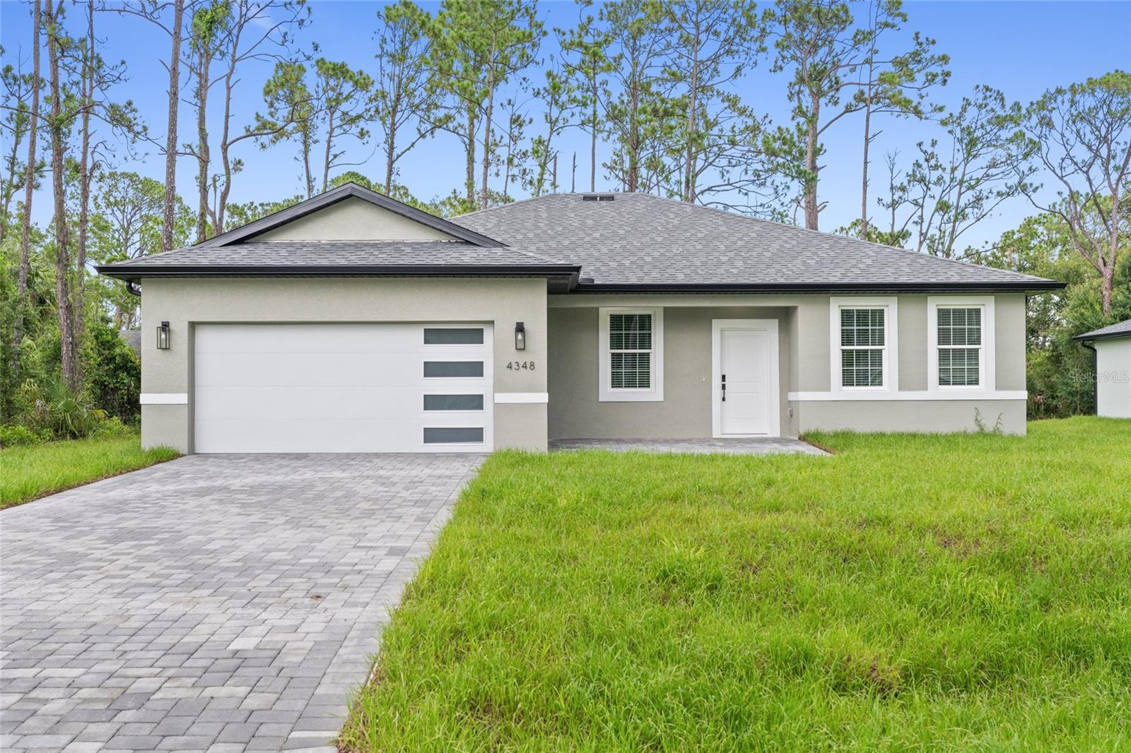 Under Construction. Home is fully completed, pending final inspection for Certificate of Occupancy. THIS PROPERTY QUALIFIES FOR CLOSING COSTS ASSISTANCE PLUS AN ADDITIONAL 1% INCENTIVE WHEN USING BUILDER’S PREFERRED LENDER
Brand new concrete block construction in the heart of North Port — no HOA, no CDD, and no flood zone (X). This beautifully crafted 4-bedroom, 3-bathroom home offers an elegant open floor plan with a epoxy finished two-car garage, and premium finishes throughout.
The gourmet kitchen features a large center island with waterfall-edge quartz countertops on both sides, soft-close cabinetry, stainless steel Samsung appliances — ideal for entertaining and everyday living. Luxury vinyl plank flooring flows throughout the home, offering style and durability.
The spacious primary suite includes his-and-hers walk-in closets and a bathroom with dual sinks and a glass-enclosed walk-in shower. A secondary bedroom includes a private en-suite bath, and a walk-in closet perfect for guests or multi-generational living. All bedrooms with blinds and modern celling fans.
Additional features include impact-resistant windows and doors, a smart thermostat, upgraded lighting, a water filtration system, and garage doors with glass panels that allow natural light in. Enjoy Florida living year-round on the covered lanai with a nicely sized backyard and extended paver driveway.
Easy access to I-75, commuting to Sarasota, Fort Myers, and top-rated Gulf Coast beaches like Siesta Key and Venice Beach. An excellent opportunity for homeowners and investors alike!
Schedule your private showing today!