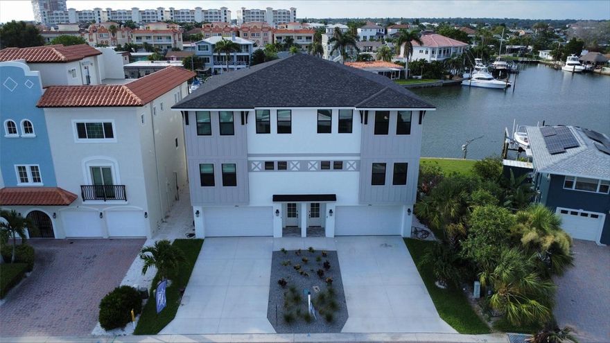 One or more photo(s) has been virtually staged. One or more photo(s) has been virtually staged. High and Dry! Elevated townhome, no living space on ground level to be damaged by flood water. Completed March 2024 BRAND NEW LUXURY WATERFRONT HOME Premier Coastal Builder Lubke Construction presents the Mimosa Townhomes. The only waterfront town homes with docks and individual pools on the Beach! NO HOA FEES! Imagine moving into a BRAND NEW HOME with all the warranties on everything! Come experience the epitome of coastal luxury living, nestled in the vibrant community of Redington Shores. Walking distance to two different coffee shops, many restaurants, beach shops and more! Each unit features 2816 sf indoor/ outdoor covered space. Enjoy sunrises and sunsets from the covered lanais on each of the three levels. This home is designed to capitalize on the water views. Watch dolphins cruise right past your dock. 1820 sf climate-controlled space with 4 bedrooms 3 full baths. NEW Seawall plus NEW Decking on Dock. Main level has 10’ tall ceilings, all levels have 8 foot solid core doors. The modern wide open kitchen is a culinary masterpiece, custom designed with floating shelves, built in custom hood, clad with ship lap and all stainless steel appliances. The oversized island has tons of storage and a 4 person seating area, making every meal an exquisite experience. Master bedroom with 2 walk in closets. 2 car garage, indoor changing area for pool at ground level, extra garage storage. Ground level entry for ease of use plus prep package for 3 Stop elevator. High performance HVAC system with 2 stand alone central units to maximize efficiency on each floor. 100% masonry construction on ALL floors, built on piling foundation, impact windows and doors, roof with secondary water barrier. Builder also had natural gas brought in specifically for this new property (the only one on the street). Gas range, tankless gas water heater, gas dryer, prep for gas pool heater. All closets built out with ventilated wood shelving. Window treatments included.
