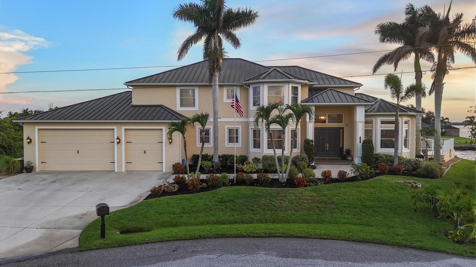 Introducing “River Breeze at Paradise Point” – the whimsical name of this breathtaking property, affectionately bestowed by the current owners. This stunning waterfront estate, stretching across 0.39 acres, is perched along the Myakka River with quick access to Charlotte Harbor and a 30-minute boat ride to the Gulf. It’s every boater’s dream to the best fishing in Southwest Florida, featuring 185 feet of concrete seawall, a 167-foot captain’s walk, and a 2023 metal-roofed boathouse with a 16,000 lb remote-controlled boat lift. Enjoy dolphin, manatee, and bald eagle sightings, or cast a line for record snook, world-renown tarpon, and redfish—all from your backyard. The home offers 3,825 sq ft of living space and a spacious, well-organized 1,327 sq ft 4+ car garage with 10.5-foot ceilings. Inside, the soaring 20-foot foyer with a sweeping staircase leads into a bright music room with 12-foot bamboo tray ceiling, and an entertainer’s dream kitchen featuring a massive quartz island, updated cabinetry, stainless appliances, and three built-in dishwashers. The kitchen flows seamlessly into the dining and bar areas and out to a 56-foot screened patio and extended lanai—perfect for year-round indoor-outdoor living. Step out to the heated saltwater pool, surrounded by open-air lounge space ideal for relaxing in the Florida sunshine. The primary suite is a private retreat with a sitting area, two walk-in closets, a luxurious 14x14 bathroom with a 5x7 glass shower, and direct access to a private waterfront balcony. The primary guest suite also features a private balcony and river views. Every bedroom is en suite, ensuring comfort and privacy for guests. Throughout the home, enjoy travertine and engineered wood flooring with porcelain tile in 2nd level bathrooms, detailed crown molding, and abundant storage including multiple custom closets. Additional recent upgrades include a new standing seam metal roof (house and boathouse), two new A/C units with whole-home UV filtration, spray foam insulation, PECS plumbing system, impact-resistant windows and doors throughout, and fresh interior/exterior paint. The pool features a new heat pump, chlorine generator, and variable-speed pump, while rebuilt decks and upgraded kitchen and baths further elevate the home's quality and style. Tucked away in Gulf Cove, a hidden gem community known for its quiet streets, friendly neighbors, and walkable, bike-friendly atmosphere, this exceptional home offers luxury, comfort, and breathtaking water views—delivering unmatched waterfront living in a peaceful coastal setting.