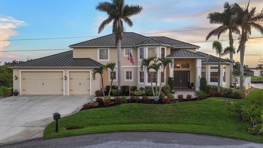 Introducing “River Breeze at Paradise Point” – the whimsical name of this breathtaking property, affectionately bestowed by the current owners.  This stunning waterfront estate, stretching across 0.39 acres, is perched along the Myakka River with quick access to Charlotte Harbor and a 30-minute boat ride to the Gulf. It’s every boater’s dream to the best fishing in Southwest Florida, featuring 185 feet of concrete seawall, a 167-foot captain’s walk, and a 2023 metal-roofed boathouse with a 16,000 lb remote-controlled boat lift. Enjoy dolphin, manatee, and bald eagle sightings, or cast a line for record snook, world-renown tarpon, and redfish—all from your backyard. The home offers 3,825 sq ft of living space and a spacious, well-organized 1,327 sq ft 4+ car garage with 10.5-foot ceilings. Inside, the soaring 20-foot foyer with a sweeping staircase leads into a bright music room with 12-foot bamboo tray ceiling, and an entertainer’s dream kitchen featuring a massive quartz island, updated cabinetry, stainless appliances, and three built-in dishwashers. The kitchen flows seamlessly into the dining and bar areas and out to a 56-foot screened patio and extended lanai—perfect for year-round indoor-outdoor living. Step out to the heated saltwater pool, surrounded by open-air lounge space ideal for relaxing in the Florida sunshine. The primary suite is a private retreat with a sitting area, two walk-in closets, a luxurious 14x14 bathroom with a 5x7 glass shower, and direct access to a private waterfront balcony. The primary guest suite also features a private balcony and river views. Every bedroom is en suite, ensuring comfort and privacy for guests. Throughout the home, enjoy travertine and engineered wood flooring with porcelain tile in 2nd level bathrooms, detailed crown molding, and abundant storage including multiple custom closets. Additional recent upgrades include a new standing seam metal roof (house and boathouse), two new A/C units with whole-home UV filtration, spray foam insulation, PECS plumbing system, impact-resistant windows and doors throughout, and fresh interior/exterior paint. The pool features a new heat pump, chlorine generator, and variable-speed pump, while rebuilt decks and upgraded kitchen and baths further elevate the home's quality and style. Tucked away in Gulf Cove, a hidden gem community known for its quiet streets, friendly neighbors, and walkable, bike-friendly atmosphere, this exceptional home offers luxury, comfort, and breathtaking water views—delivering unmatched waterfront living in a peaceful coastal setting.