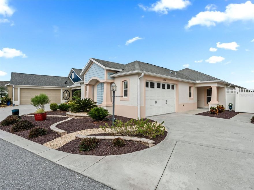 Spectacular WATERFRONT & GOLF-FRONT home – Steps to Lake Sumter Landing!  This one-of-a-kind property at EDGEWATER BUNGALOWS offers the perfect blend of location, lifestyle, and comfort. Situated on a premier waterfront and golf front site, this residence showcases sweeping views of LAKE SUMTER and a serene setting.  Inside, you’ll find an open floor plan with soaring high ceilings, creating a bright and spacious atmosphere. The kitchen featuring maple cabinetry includes LG stainless steel appliances (2023), Bosch Dishwasher (2025) and an open floor plan - open to the main living areas. A climate-controlled, SPACIOUS, enclosed lanai with high-end glass windows and screens, invites you to relax or entertain year-round while enjoying the beautiful backdrop. No carpet throughout this lovely home featuring tile and laminate floors- this versatile layout is designed for easy living. Just a short walk to Lake Sumter Landing’s entertainment, dining, and shopping - this location can’t be beat. This home has NO BOND!  New landscaping installed in 2023.