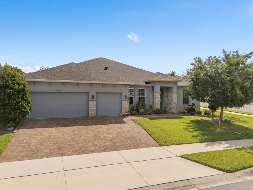 From the Stone Faced exterior, to the Neutral Palette Inside, Welcome to this Gorgeous 2,865 Sq Ft One Story, 4 Bedroom, 3 Bathrooms, Full Size 3 Car Garage Brentwood Model with the Den Option, NO CARPET and a PAID OFF WHOLE HOUSE SOLAR SYSTEM with a BATTERY BACK-UP System (approx. $90K). The Solar System is monitored with an App on your Device and offers the opportunity for VERY LOW ELECTRIC BILLS and Stabilized Future Electric Bills. Take advantage of this paid-off system. This home is located in the Highly Sought after Ardmore Reserve Community in Minneola and shows as if it was featured in House Beautiful Magazine. Built in 2019, the Upgrades are noticeable throughout, featuring a Den/Office, Covered Lanai with a Porcelain Tile Floor, Extended Paver Patio with a Firepit, Fenced in yard with 2 Gates. A chef's dream Gourmet Kitchen, Amazing Oversized Island with a Breakfast bar, Pendent Lighting, Quartz Counter Tops, Gas Cooktop, Stainless Hood Vent, Tiled Backsplash, Built-in Microwave, and Oven. Entertain in the Beautiful Family Room with an 11' Tray Ceiling that just adds to the Spaciousness of the Room. Ceramic Wood Look Tile Throughout the Main Living Area and Luxury Vinyl Plank in the Bedrooms. 8' Doors and Plantation Shutters are Throughout the Home, adding to the Grand Appearance. An Oversized Primary Suite is just a start upon entry. Relax in the Primary En-Suite after a day at work with Features such as a Separate Garden Tub, Large Separate Shower with a Frameless Enclosure, Rainfall Showerhead, and a Main Shower Head with Touch Panel Controls. A Water Closet offers Privacy, and the Large Walk-In Closet has a Fantastic Organization System. The Full Size 3 Car Garage offers a Side Door, Great Ceiling Height and Plenty of Overhead Storage Ceiling Racks for your convenience. When it's time to enjoy the Outdoors, the Backyard Features a Large Covered Lanai with a Natural Gas Connection (no more lugging the propane tanks around) and a Firepit for the evenings to sip on your favorite beverages under the stars. The Ardmore Reserve Community Amenities Features a Swimming Pool, Sun Deck, Veranda, and a Shaded Playground. Minneola is welcoming many future eateries, and an Advent Health Hospital is a few minutes away. The Minneola Charter School is also a great addition to the area and is on Education Ave, as well as Grassy Lake Elementary and Lake Minneola High School is a few minutes away.  Ardmore Reserve is close to South Lake Hospital, Medical Offices, VA, Shopping, Publix, Target, Home Depot, Lowes, Starbucks, Restaurants, Golf Courses, National Training Center (NTC), Boating and the Quaint Downtowns of Clermont and Winter Garden. For your travel convenience, Ardmore Reserve is within a few minutes of the Florida Turnpike with easy access to Disney and Other Attractions (30 minutes), Orlando International Airport (40 minutes). Come and take a look at this beautiful home and enjoy the conveniences that Minneola offers. Ardmore Reserve DOES NOT have a CDD.