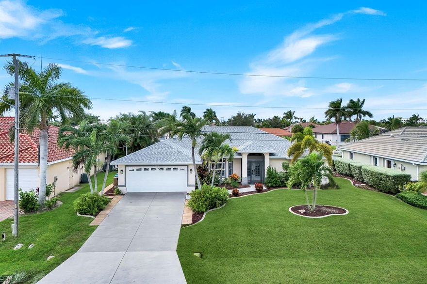 WESTERN EXPOSURE GULF-ACCESS POOL HOME w/DOCK AND LIFT! Enjoy the ultimate Southwest Florida lifestyle, from the moment you arrive! You are greeted by the lush tropical landscaping, lava rock accents, and screened double French door entry create an inviting first impression. Inside, soaring vaulted ceilings and sunlit open spaces set the tone for relaxed coastal living. The great room flows effortlessly into the dining area and kitchen, where granite countertops, tile backsplash, under-cabinet lighting, and a large farmhouse sink elevate every meal. KitchenAid stainless steel appliances, a breakfast bar, pantry, and cozy dining nook overlooking the water make it as practical as it is stunning. The owner’s suite offers private sliders to the lanai and a luxurious ensuite bath with dual sinks, a makeup vanity, a large walk-in shower, a garden tub, and a spacious walk-in closet. The split floor plan provides privacy for guests, while a nautical-themed pool bath with shiplap detail and chair rail adds a fun coastal touch. The home features updated light fixtures and fans, fresh tile flooring completed in 2021, a new roof (2022), new screens, and an A/C that’s serviced every three months with a UV purification system. The water heater and AC system are also newer ensuring peace of mind for years to come. Step through sliding glass doors to the expansive lanai, where a sparkling electric heated salt-water pool with waterfall feature and western exposure create the perfect backdrop for gorgeous Florida sunsets. The screened enclosure offers plenty of room for outdoor dining and lounging, surrounded by lush palms and a fenced yard for added privacy. A private dock with lift provides premium canal access, perfect boating adventures to open water in approximately 35 minutes. Back yard has dog run keeping those furry family members safe and sound. Designed for easy living and memorable entertaining, this home embodies the essence of Cape Coral’s waterfront charm—close to shopping, dining, and parks, yet tucked away in a quiet neighborhood where every evening ends with a golden sunset over the water. World class fishing, white sandy beaches and year round temperate weather awaits you!