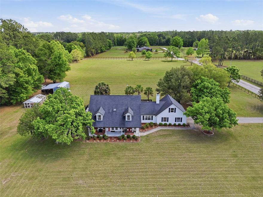 Welcome to your own private retreat—where comfort, style, and country living come together on 5 fully fenced acres in one of the area’s most sought-after locations. This stunning 4-bedroom, 3-bath pool home offers the perfect balance of peaceful seclusion and everyday convenience. Start your mornings on the inviting front porch, the ideal spot to sip coffee and soak in the serene surroundings. Inside, the thoughtfully designed layout features two spacious living areas—including a cozy fireplace—along with a formal dining room that’s perfect for hosting gatherings. The kitchen is both functional and beautiful, with a charming eat-in area and a sink perfectly positioned to overlook the picturesque backyard. Throughout the home, you’ll find high-end finishes including custom cabinetry, quartz countertops, luxury vinyl plank flooring (no carpet!), and stylish touches like wood shiplap, crown molding, and built-ins that provide both character and ample storage. The spacious primary suite is filled with natural light and offers two walk-in closets along with a well-appointed bathroom featuring dual vanities. Step outside through either of the two sliding glass doors and discover your own backyard oasis—complete with a fenced saltwater pool featuring two tranquil fountains, an expansive paver patio, and an additional deck ideal for entertaining, grilling, or simply unwinding. This property is designed for enjoying the outdoors, with a fire pit for cozy evenings, a horseshoe area for friendly competition, and a fully equipped chicken coop with plumbing. The 12x28 powered outbuilding—with A/C and water—offers incredible versatility as a home gym, office, workshop, or guest overflow space, plus a lean-to for storing equipment or recreational toys. The two-car garage is equally impressive with added cabinetry for optimal organization. Recent upgrades—including a Tesla charger, new pool pump, resurfaced pool, spray foam insulation, gutters, and more—provide peace of mind and added value. With no HOA and plenty of room for animals, this property offers true freedom and flexibility. Ideally located just minutes from I-75 with easy access to High Springs, Alachua, Gainesville, and Lake City, and close to the Santa Fe River and renowned natural springs. This exceptional property is more than a home—it’s a lifestyle. Don’t miss your opportunity to make it yours.