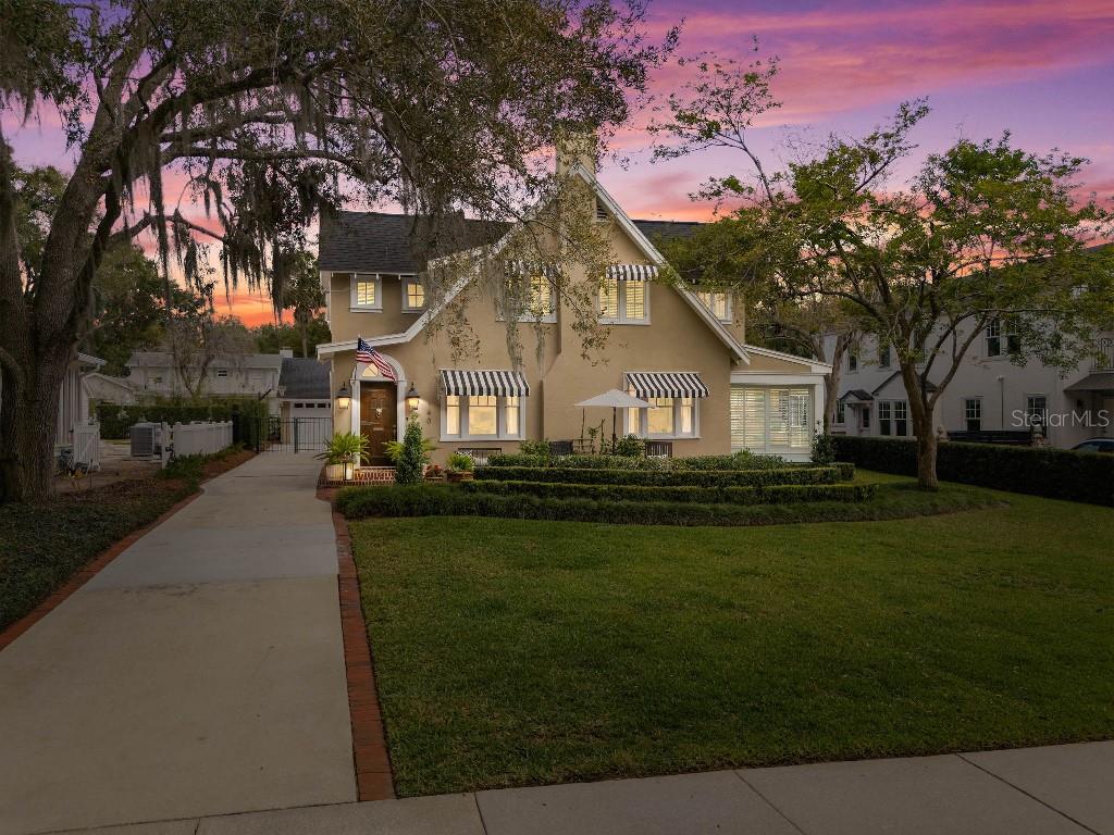 Welcome to this beautifully renovated century home on one of the most picturesque brick streets in Olde Winter Park. Take a leisurely stroll down to Lake Mizell or enjoy the views from its large front patio. This classic pool home is filled with charm, natural light and is designed for easy entertaining. The spacious layout offers multiple rooms for every occasion, including a bright sunroom, cozy living room with a fireplace, and a large welcoming family room. The gourmet kitchen features custom wood cabinets, quartzite counters, a convenient office nook and an adjoining breakfast room, while the formal dining room boasts elegant moldings and built-in corner cabinets. A secret basement presents options for additional storage or a wine cellar.
The second floor features a generously- sized master suite, two additional bedrooms, two updated baths, and a versatile nursery or bonus room, perfect for a study or home office. The property includes a detached two-car garage and a charming guest house with a bedroom, bath, and loft area.
Newly renovated resort back yard includes heated salt water pool and spa, multiple seating areas, complete with gas hookups for fire pit and outdoor kitchen and a maintenance-free travertine and turf pool scape. You’ll love the inviting ambiance of both this home and its vibrant Winter Park location.