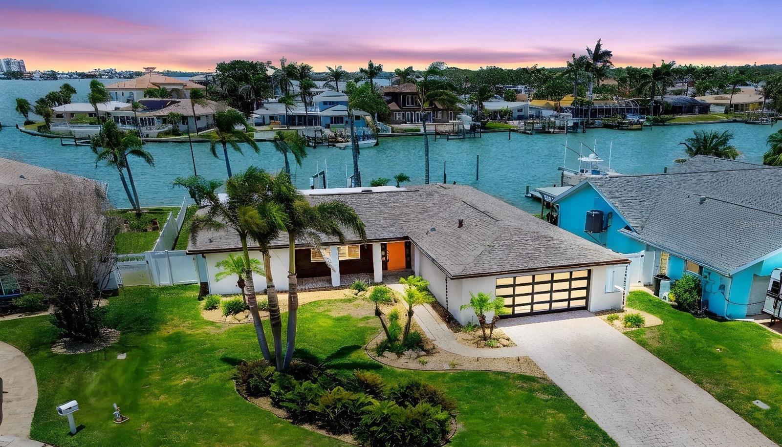 JUST REDUCED! RARE FIND! MOVE- IN READY, BEAUTIFUL, NEWLY REMODELED, WATERFRONT HOME WITH OPEN FLOOR PLAN! Magnificent open water, westerly views across Boca Ciega Bay fill this beautiful contemporary home with sunset views from all common areas, the master suite and 2nd bedroom! This gem is located in the highly desirable community of Oakhurst Shores, just north of the Madeira Beach Causeway in unincorporated Pinellas County. New Seawall in 2023 (pool ready), 10K lb boat lift updated in 2019 and 500 sq ft composite dock with catwalk installed in 2016. Shingle Roof 2017, Flat Roof 2025. Additional features include Control 4 Automation system. This system includes access control (unlock your doors remotely) whole house audio (ceiling stereo sound in every room), distributed video (watch multiple sources/TV’s included), 10-camera surveillance system (view what's going on from anywhere), HVAC control (adjust thermostat remotely) and lighting control throughout (remote lighting control with lighting scenes for moods by time of day). This system has a value over 100K and yes all can be controlled with Alexa. 30 AMP RV/Boat Outlet by driveway. Enjoy exceptional waterfront living on the mainland with no thru traffic by land or sea. 15 minutes to the open waters of the Gulf of Mexico by boat or bicycle to the beach. Plenty of shopping nearby, entertainment, Pinellas Trail and tennis/pickleball courts. You can even purchase your groceries by boat! This quiet neighborhood features great schools, underground utilities, natural gas, and a voluntary HOA and no minimum lease terms which is a great potential for Airbnb. This 4/2.5/2CG was damaged by Helene, the only time this neighborhood has ever flooded. The flood damage was remediated, repairs are finished, and the remodel is complete. SEE THIS BEAUTIFUL HOME'S EXTENSIVE FEATURE LIST IN THE PUBLIC ATTACHMENTS!!! CALL TODAY TO SCHEDULE TO SHOWING! DON’T MISS YOUR CHANCE TO OWN A GORGEOUS, REMODELED HOME IN THIS HIGHLY SOUGHT AFTER COMMUNITY!