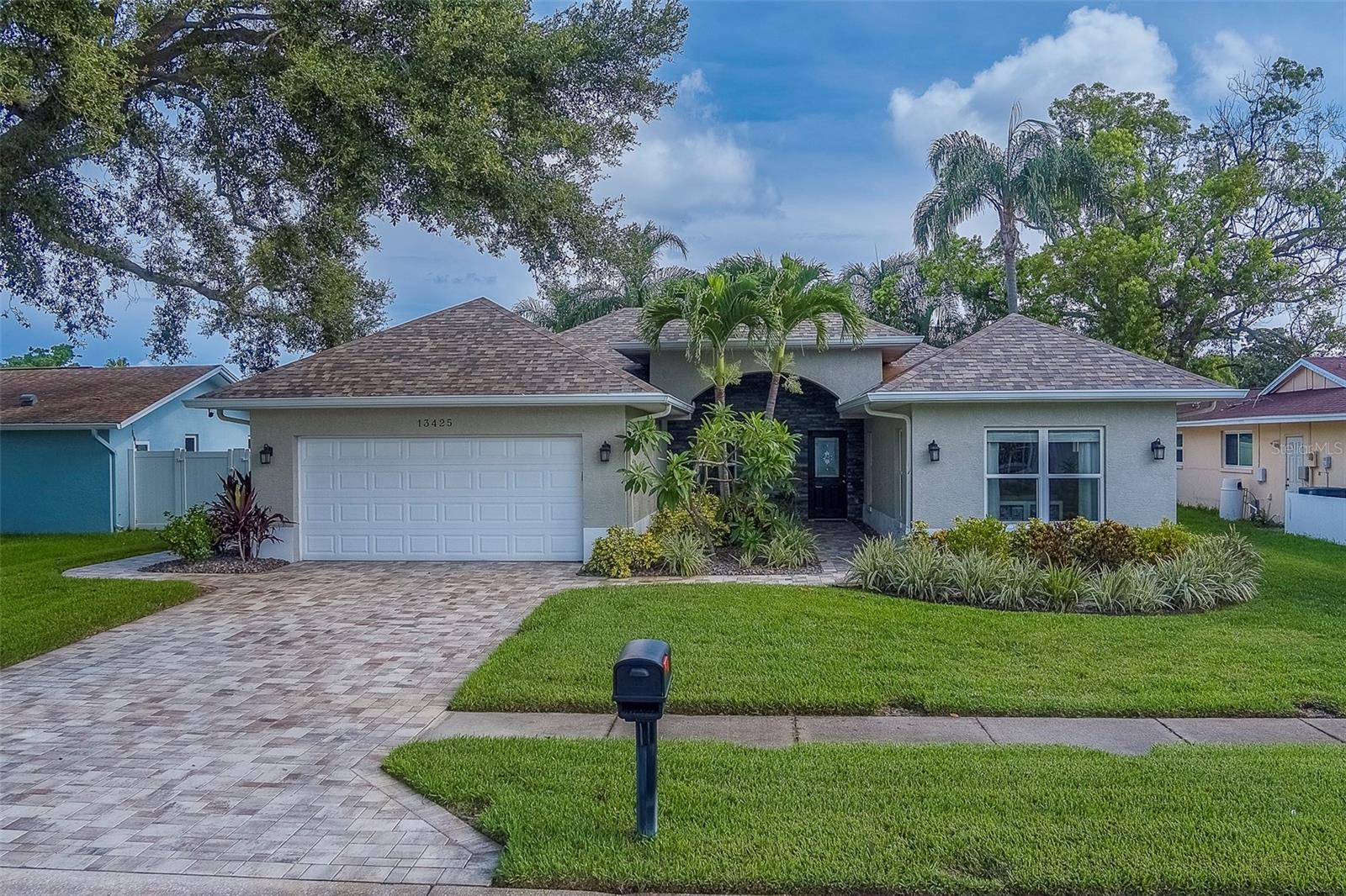 Welcome to this meticulously re-built 3-bedroom, 2-bathroom home, nestled in the highly sought-after Del Prado neighborhood. Completely re-built in 2015, this home boasts elegant volume ceilings, 8-foot doors, and pristine travertine floors that flow throughout the entire space.
This home features an exceptional elevation that stands out in the neighborhood, complete with a charming covered front entry and a pavered walkway. The newly pavered driveway adds even more curb appeal and welcomes you into this beautifully designed home. Step into the spacious, open-concept living area, where natural light pours through large windows, accentuating the stunning finishes. The chef-inspired kitchen is a dream, with granite countertops, stainless steel appliances, and custom wood cabinetry. Whether you're hosting a dinner party or preparing a family meal, this kitchen will elevate your cooking experience. The screened-in rear patio offers a tranquil retreat, perfect for sipping your morning coffee or enjoying a relaxing evening with a glass of wine. The heated pool is surrounded by lush landscaping and provides the perfect backdrop for entertaining or unwinding after a long day. This home also includes a fully fenced yard with stylish white vinyl fencing for ultimate privacy. The 50-amp plug in the garage is ideal for your electric toys, offering convenience and versatility. Located just minutes from shopping, dining, and the world-famous Gulf Beaches, you'll love the convenience of this prime location. Plus, the home is zoned for highly-rated Seminole Schools, including Oakhurst Elementary, making it perfect for families. With its impeccable condition, pride of ownership is evident throughout. Don’t miss the chance to own this stunning home in Del Prado – schedule your appointment today and make this dream home yours!