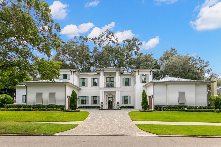 Stunning custom pool home built by Alvarez Homes located on one of Beach Park's prettiest streets. Meandering sidewalks & majestic oaks add to the charm of the neighborhood and the ambiance of the home. Dramatic open floor plan with 13’ coffered/box beamed ceilings downstairs (except 14’ in the master) & 10’ on the 2nd floor. The spacious great room with beautiful views of the backyard, welcomes you into the home with coffered beam ceiling & a gorgeous fireplace with custom bookshelves that leads to the dining area with a built-in buffet. Entertaining is a breeze in the chef's kitchen featuring Wood-Mode cabinetry, 2 Sub-Zero refrigerator/freezers, Wolfe 6 burner gas range with griddle, an extra microwave/convection oven, warming drawer, Kohler farm sink, prep sink, & quartz Calacatta Vicenza countertops. The downstairs owners retreat is spacious and offers a beautiful master bathroom with a soaking tub and large walk-in shower, 24x24 Calacatta porcelain tile floors and dual vanities along with 2 large custom walk-in closets. Enjoy the convenience of the downstairs study/den with a Pecky Cypress wood ceiling. Upstairs features 3 ensuites plus a cozy loft area with built-in bookshelves and French doors out to the front balcony. Relax under the gorgeous lanai with an outdoor fireplace, gas grill, ice maker, refrigerator, and wood ceiling overlooking the expansive backyard, pool & spa. The home features a whole house Control4 Entertainment system, a 24KW Kohler natural gas powered generator with automatic transfer switch, water filtration and softener. Features that help to lower insurance costs: 2 story cement block with core fill masonry foam insulation, 40 year metal roof, Hardie plank siding, & PGT insulated & impact resistant windows. 3 car garage. Minutes to the Westshore & downtown business districts, TIA, International Mall & the many South Tampa restaurants.