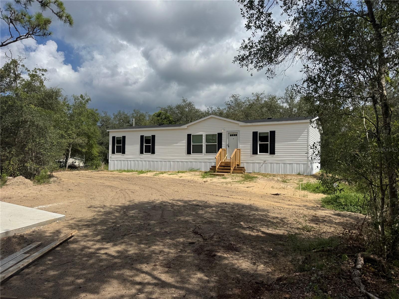 Under Construction. Almost Completed. Brand New Home on Nearly an Acre in Circle M Ranchettes! Be the first to live in this beautiful, brand new double wide mobile home located in the peaceful community of Circle M Ranchettes. This home features all-new systems including aerobic septic, well, electric, and A/C—offering peace of mind and move-in-ready convenience. Situated on just under an acre of land, there’s plenty of room for your family, animals, or all your outdoor toys. You'll love the quiet setting with paved roads, no flood zone concerns, and desirable RURMH zoning, giving you the flexibility and freedom you’ve been looking for. Enjoy nearby shopping, dining, and medical centers for your daily needs. For outdoor enthusiasts, the stunning Nature Coast is right at your doorstep, with over 42 miles of paved Withlacoochee Bike Trails to explore. Indulge in world-class Gulf Coast fishing in Crystal River and Homosassa River, or unwind in the clear waters of the Rainbow River in Dunnellon. Whether you're biking, fishing, or kayaking, adventure is always just around the corner! Schedule your personal showing today and experience all that this quiet community and home have to offer.