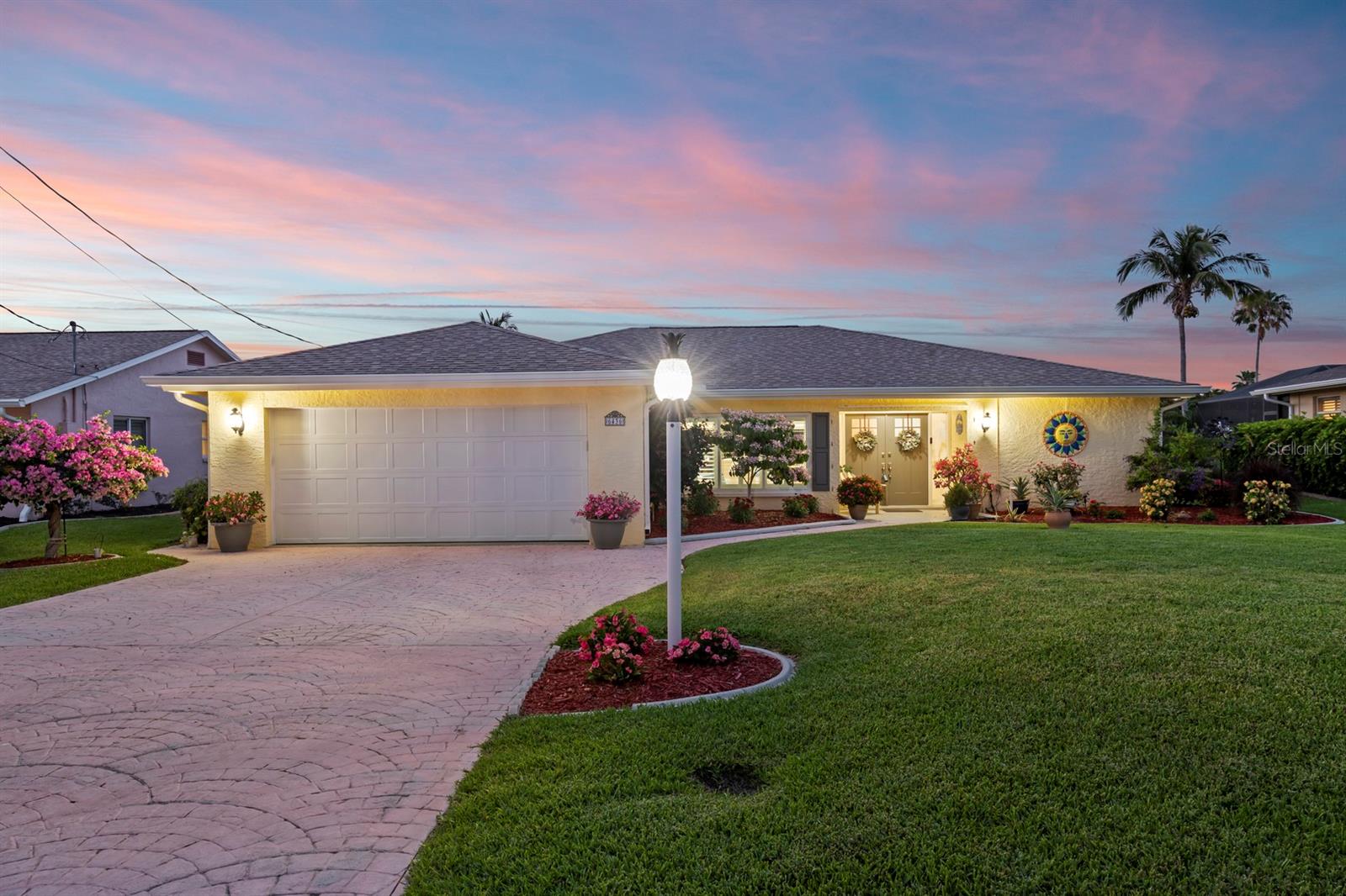 Gulf-Access Pool Home with Dock, Lift, and Unobstructed Gulf Access! Beautifully renovated, this one-level 3-bedroom, 2-bath home offers nearly 2,000 SF of open-concept living on a prime canal with direct Gulf access. Boaters will love the private dock with a 7,000 lb. lift and the rare ability to fish or crab right from the backyard. Enjoy unobstructed boat rides through Estero Bay to the Gulf, offering seamless access to open waters. The outdoor space is built for entertaining, with a PebbleTec-finished Jackson pool and a 10-foot insulated covered lanai running the full length of the home for comfortable enjoyment of poolside relaxation and dining. Inside, the chef’s kitchen impresses with Calacatta Gold quartz counters and backsplash, white and navy shaker cabinetry, a massive 13-foot island, premium LG appliances—including a microwave with built-in air fryer—and custom pull-out drawers in every cabinet for maximum functionality. Two pantry cabinets provide even more storage. The private primary suite is thoughtfully separated from the guest bedrooms, and both baths feature stylish quartz countertops, shiplap accents, and upgraded fixtures. Additional highlights include BRAND NEW FLOOD BARRIERS ($15K Investment), tile flooring throughout interior, plantation shutters, crown molding, custom closet organizers, and shiplap detailing in the great room and baths. Major updates include a new roof and electrical system (2023), new tankless water heater (2023), plumbing (2022), and AC unit (2022). The 2-car garage is finished with a workbench, built-in shelving, and epoxy-coated flooring. Surrounded by lush landscaping with flowering trees, a banana tree, and raised garden beds filled with pineapples, tomatoes, and herbs, this home is a tropical oasis. With NO HOA IN A PRIME LOCATION, it’s ideal for full-time living, a seasonal retreat, or an income-producing vacation rental. FURNITURE IS NEGOTIABLE! Minutes from offshore fishing, beaches, and waterfront dining by car or boat—this is Florida living at its finest!