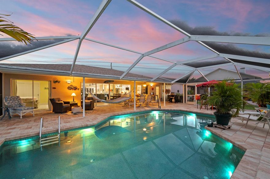 Beautifully renovated and meticulously maintained by full-time owners, this single-level 3-bedroom, 2-bath home offers nearly 2,000 square feet of open-concept living on a premier canal with direct, unobstructed access to open water and short, effortless boat rides to the Gulf. Boaters will love the private dock with a 7,000 lb. lift and the rare ability to fish or crab right from the backyard. Designed for outdoor living, the backyard features a PebbleTec-finished Jackson pool and a full-length 10-foot insulated covered lanai—perfect for poolside lounging, dining, and entertaining year-round. Inside, the chef-inspired kitchen shines with Calacatta Gold quartz countertops and backsplash, white and navy shaker cabinetry, and an impressive 13-foot island. Premium LG appliances include a microwave with a built-in air fryer, while custom pull-out drawers and dual pantry cabinets maximize storage. The private primary suite is separated from guest quarters, and both baths showcase quartz countertops, shiplap accents, and upgraded fixtures. Additional highlights include brand-new flood barriers ($15K), tile flooring throughout, plantation shutters, crown molding, custom closet organizers, and shiplap detailing in the great room and baths. Major updates provide peace of mind: new roof and electrical system (2023), tankless water heater (2023), plumbing (2022), and AC (2022). The 2-car garage offers built-in shelving, a workbench, and epoxy flooring. Surrounded by lush landscaping with flowering trees, a banana tree, and raised garden beds with pineapples, tomatoes, and herbs, this home is a tropical retreat. With no HOA and a prime location, it’s ideal for full-time living, a seasonal getaway, or a high-performing vacation rental. Furniture negotiable. Minutes from offshore fishing, beaches, and waterfront dining—this is Florida living at its finest.