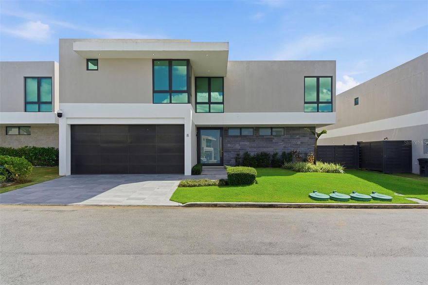 Live big in this contemporary Monaco Flex, where natural light and smart functionality come together in a layout designed for today—and adaptable for the future. Featuring 4 bedrooms, 4.5 bathrooms, and approximately 3,317 sq ft of construction on a 468 m² lot, this residence delivers true spaciousness from the moment you arrive.

On the first level, you’ll find a grand salon with 18-foot ceilings and expansive windows that seamlessly connect the living, dining, family, and kitchen areas in an open-concept design—ideal for entertaining or everyday living. The standout feature is the ground-floor FLEX space, complete with a full bathroom and walk-in closet, perfect to use as a main-level primary suite, guest suite, private office, studio, gym, or whatever your lifestyle requires.

Upstairs, the home continues to impress with a well-planned layout for comfort and privacy: the primary suite includes a walk-in closet and en-suite bathroom; a junior suite offers its own private bathroom; and two additional bedrooms with walk-in closets share a Jack & Jill bathroom. Modern touches like open views to the first level and glass railings elevate the home’s contemporary feel and sense of openness.

Offered fully equipped and move-in ready: 7 inverter A/C units, a 25 kW generator, a 500-gallon water cistern, a state-of-the-art water purification system, a security camera system, and upgraded tile finishes throughout.

Riviera Parkview offers exclusive resident amenities: pool, gym, activity rooms, tennis courts, beach tennis, basketball court, playground, and 24/7 security. Conveniently located near San Juan Metro, restaurants, shopping centers, private schools, and Bayamón Golf Course.

Schedule your private showing today.