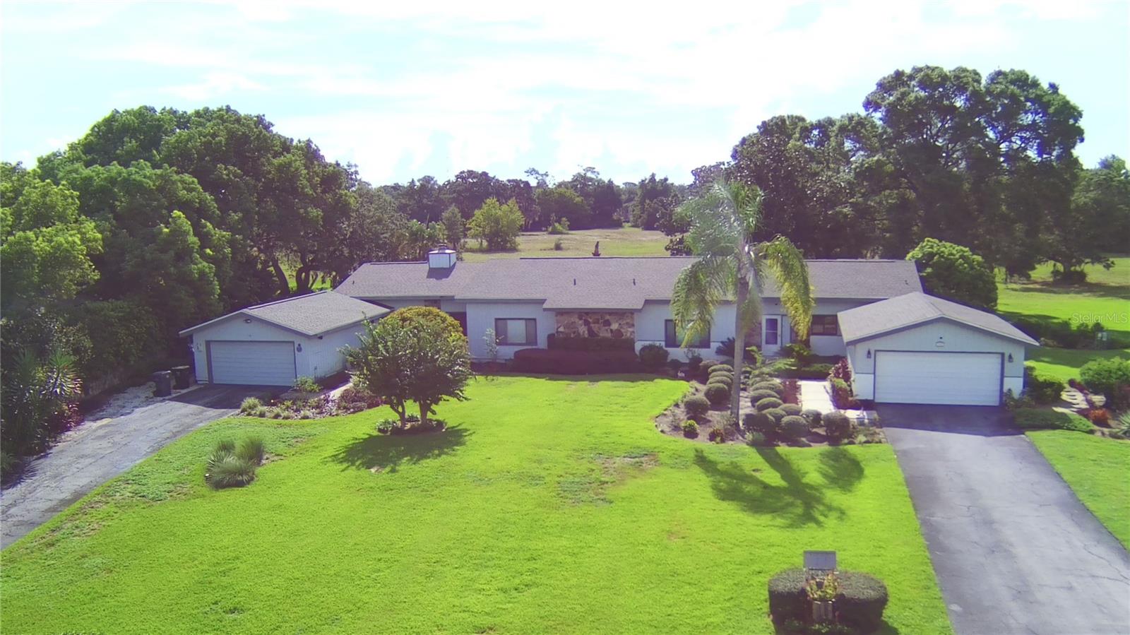 SPACIOUS 2 BEDROOM, 3 FULL BATHS PARTIALY FURNISHED TOWNHOUSE WITH OVER 2,200 SQ.FT LOCATED IN GATED GRENELEFE COMMUNITY. Welcome to 118 Canterbury Dr, a beautiful townhouse with soaring vaulted ceilings, a Florida room with an entire wall of windows that have gorgeous views overlooking the 1/2 acre lot, an oversized 2 car garage and NEWER ROOF AND WATER HEATER. A foyer, open floor plan with a dining room, great room and Florida room. The dining room is open to the great room. A wall of windows which bring in lots of natural light and serene landscaped, wooded views. The kitchen features a full appliance package, a breakfast bar and pantry with cabinetry. The master suite has a separate office/dressing area with multiple closets & mirrored vanity and a master bathroom with separate garden tub and separate shower. Guest bedroom is spacious in size and conveniently located next to the Jack and Jill bathroom with a walk-in shower. The included washer and dryer can be found off the kitchen and a guest full bath. The 0.41 acre lot features lush mature landscaping with an irrigation system and shaded side patio. Located in a gated community with private roads. Enjoy scenic walks, biking and golf carts are allowed. Centrally located between Tampa and Orlando and less than 30 miles from Disney World. SELLER IS OFFERING A $5,000.00 CREDIT FOR NEW FLOORING.....PARTIALLY FURNISHED! HOME IS WIRED FOR A 50 AMP EMERGENCY ELECTRICAL BACKUP PLUG TO RUN THE HOUSE.