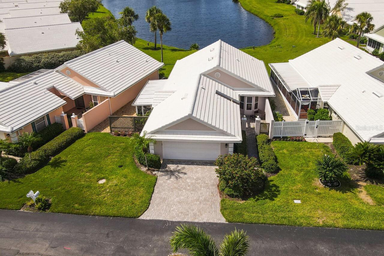 Relax and enjoy the beautiful southern lake views from this freshly painted 2 Bedroom plus an under air Sunroom Maintenance free Villa located in Harrington Lake At The Plantation Golf and Country Club. A Perfect Winter Retreat or year round Home. Features include a Pavered Driveway, sidewalk and courtyard; beautiful Kitchen complete with Custom Wood White Raised Panel Cabinets, Granite Counters and SS Appliances; 2 Bathrooms with walk in Showers; no carpet: luxury Vinyl, porcelain tile and new flooring in main bedroom; plus a screened side porch off the Kitchen and Dining Room. New Roof 2023. Harrington Lake Residents enjoy a Clubhouse and Community Pool very Active with Social Gatherings. If Golf, Tennis, Pickleball or Fitness are your passions then membership is available at The Plantation Golf and Country Club as well. Now is your chance to say Goodbye to Cold Winters and live the Good Life in beautiful Venice FL!