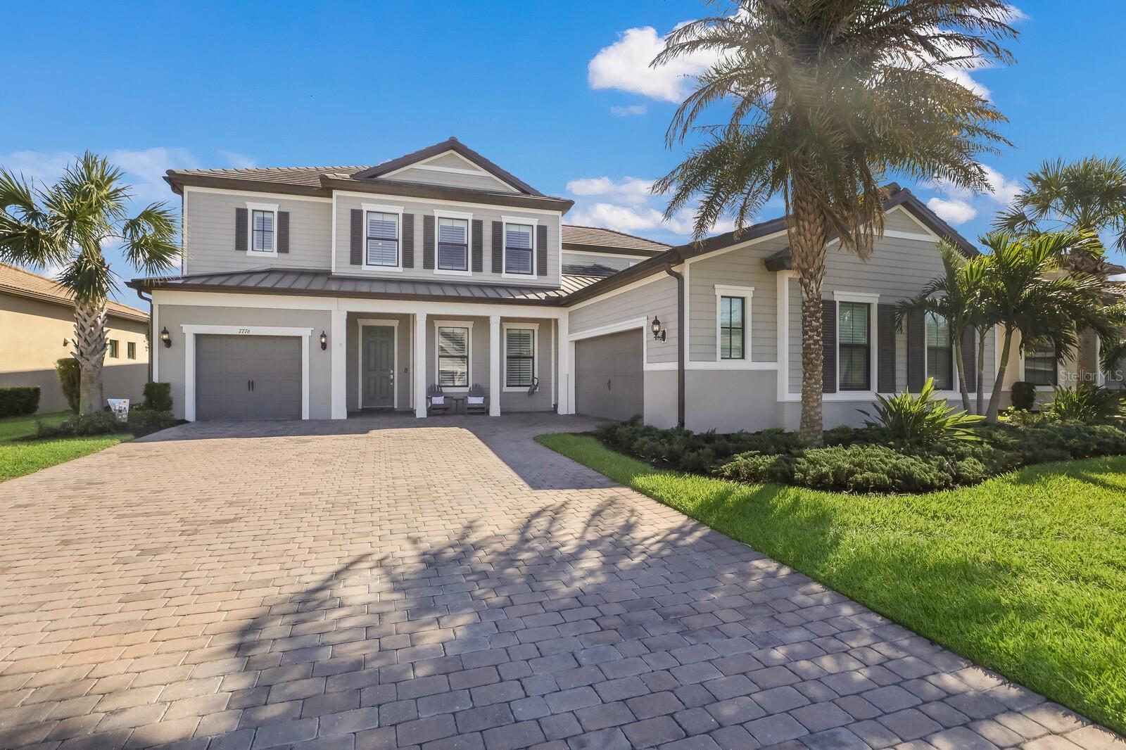 This remarkable home known as the Empire model boasts over 4800 square feet in a prime location with unobstructed water views located in Shoreview at Lakewood Ranch Waterside. As you enter this exquisite home you are greeted by the elegance of the custom wood curved staircase and engineered wood flooring throughout the entire home. Luxury appointments include PGT thermal-impact glass windows and doors, custom moldings and shutters, first and second floor concrete block construction and a custom-built Butler pantry with upper glass cabinets. Impact sliders that pocket welcome the outdoors with heated pool and spa, paver lanai, outdoor kitchen, Clearview screen and picturesque views of the lake. Enjoy the gourmet kitchen that has solid wood cabinets with pull out drawers and doors with soft close. The kitchen is equipped with two pantries, tile backsplash with under cabinet lighting, quartz countertops, 30” double ovens, 5 burner Wolf gas cooktop and a built-in refrigerator. The open floor plan has great flow for entertaining with a separate dining room, a private den with French double doors and a large great room adjoining the café. Plantations shutters, custom lighting fixtures, ceiling fans, Generac whole house generator, Kinetico Water Softener, and professional landscaping are just some of the notable features this home has to offer. The elegant owners’ suite has an adjacent sitting room with lake views, large walk in closet with access to the laundry room, large walk in shower, and double vanities. The first floor has a guest room with adjoining full bath. The second floor starts with a large game/bonus room with stunning views of the lake. There are three additional bedrooms one of which offers an ensuite bath. A media/music room finishes the second floor. The two-car garage is extended four feet with a separate third car garage. The new owners will certainly treasure the location. It is a short walking distance to the amenity center, private pool, fitness center, walking trails, tennis and pickleball courts. And it is golf cart ride to Waterside Place! Room Feature: Linen Closet In Bath (Primary Bedroom).