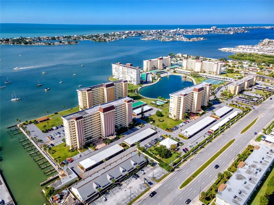 Experience resort-style living in this beautifully maintained 2-bedroom, 2-bath condo in the Hamilton House building at Sea Towers. Located on the 4th floor, this bright and spacious unit features large living room windows showcasing views of the tennis courts, private lagoon, canal, pool, and the Intracoastal Waterway, perfect for spotting dolphins and manatees.

The remodeled kitchen features white cabinetry, matching Whirlpool stainless steel appliances, an island, and opens seamlessly to the dining and living areas for easy entertaining. The primary suite includes two closets and a renovated en-suite bath, while the second bedroom offers a large walk-in closet and access to a beautifully updated guest bath with a frameless walk-in shower.

This turnkey, furnished condo, also includes double-pane windows, hurricane shutters, and one covered parking space for added comfort and peace of mind.

Sea Towers is a gated 55+ waterfront community with 24-hour security, offering an exceptional list of amenities including two heated pools (cooled in summer), fishing docks, tennis and pickleball courts, shuffleboard, putting green, fitness center, billiards, library, saunas, and a waterfront clubhouse. A full-time activities director organizes events such as bingo, cards, water aerobics, cooking classes, dances, shows, and social gatherings.

Enjoy the scenic walking path around the lagoon, picnic pavilions with grills, and beautiful sunset views from the dock or patio. Covered boat and kayak slips are available for rent when available.

Conveniently located within walking distance to Publix, restaurants, banking, and the American Legion, and just a short drive to the Gulf beaches, Seminole City Center, and the VA Hospital.

Experience the Florida coastal lifestyle where every day feels like a vacation.