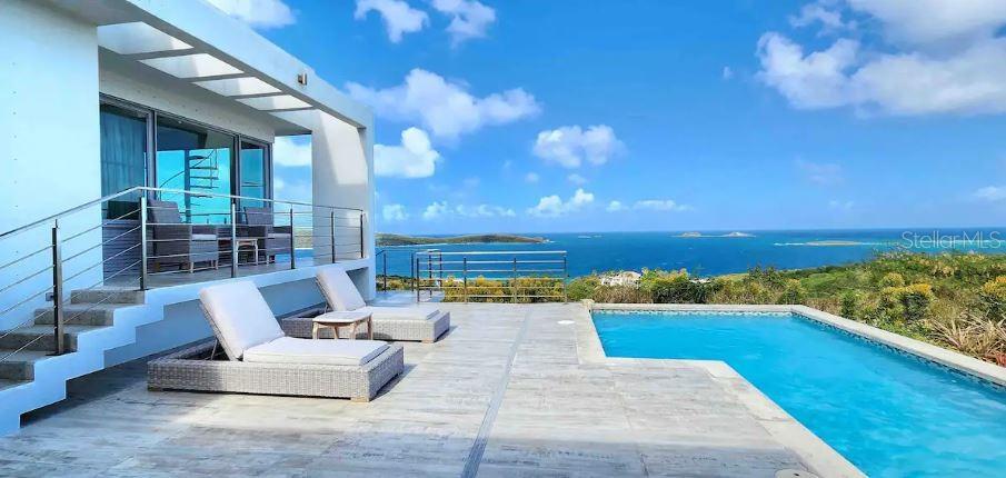 This property known as Casa Luar is a spectacular property with fabulous views.
The property is located in the Zoni Beach area of the beautiful Island of Culebra, Puerto Rico, one of the Spanish Virgin Islands. The property has simply spectacular views over the Island of Culebrita, the Island of Cayo Norte, the Island of St. Thomas of the US Virgin Islands, the Island of Tortola of the British Virgin Islands, the Caribbean Sea, and the Atlantic Ocean. The property is perfectly located and situated facing East on the windard side of Culebra. This gives the house exposure to cooling trade winds, spectacular sunrises, and views to the stars and heavens at night.
The property has 2 separate houses. The Upper house has 5 bedrooms 4.5 bathrooms full kitchen, living, dining areas and expansive outdoor balconies on the top floor. The bottom floor of the Upper house has a 1 bedroom 1 bath apartment with kitchenette and an outdoor patio.
The lower house has 2 bedrooms 2 bathrooms, full gym which could be converted to a third bedroom and a covered outdoor grill area. Both houses have their own pools. The upper house is currently rented short term "airbnb".
An absolutely spectacular property to live in one house and rent the other, as a second home, or as an investment property.