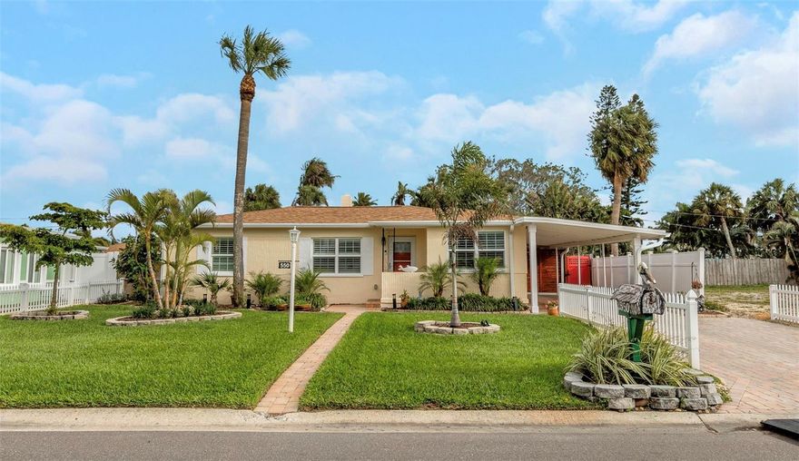 MUST SEE THIS COMPLETELY REMODELED 2 bedroom (could be  3 bedroom) with 2 full baths just a short walk to Saint Pete Beach!  The owners have great taste and didn’t hold back!  They renovated the following:  Kitchen with stainless steel appliances, quartz countertops and cabinets.  All new bathrooms, luxury vinyl flooring, crown molding, exterior was just painted/sealed, new electric water heater.  Roof is 2022.  HVAC 2024 with new duct-work.  It has double-pane hurricane rated windows with plantation shutters.  The backyard is an entertainer’s paradise, boasting a fully fenced yard with a covered patio area to hang out with friends/family, an open deck area to get some sunshine, a covered deck area to have a morning cup of coffee, or the lawn area to start a garden or add a fire pit!  Plenty of room for a pool.  Irrigation system with reclaimed water.  2 car carport and additional 2 cars and fit in driveway. Currently there is the main living room and an additional family room/dining area that could also be a study, or the entire space could be converted into a 3rd bedroom easily.  Nestled in a prime location near Treasure Island, St. Pete Beach, and a host of vibrant attractions, this property is a rare opportunity!  This home includes 19 more months (November 2027) of prepaid transferrable flood insurance to the next owner!