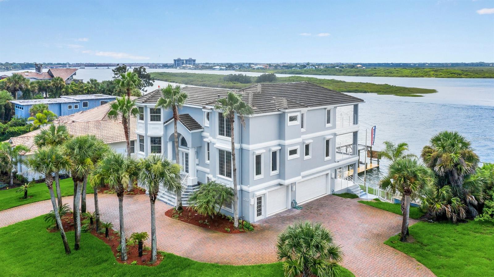 Come and see this gorgeous Intracoastal Riverfront Luxury home with views from the many back decks and balconies of sunsets over the Intracoastal Waterway. Completely renovated and modernized three story home in New Smyrna Beach island on Florida's central east coast.
This home has 5 bedrooms, 5 bathrooms. Master Bedroom has a private balcony with waterview, walking closet, amazing master bathroom with luxurious shower and bathtub. In the second floor an open-concept kitchen, dining and living room area with waterview. In addition to impressive architectural detail, it provides a spectacular vantage point and is accessible by stairs or by a 3 stop elevator.
This home is in deep water , 9-10 ft depth at low tide. The location is perfect, with easy access via deep water motor yachting to Ponce Inlet and the Atlantic Ocean. The beach is just a short walk from your front door. It is just a few minutes walk to Historic Flagler Avenue shops and restaurants. Relax in a leisurely waterfront lifestyle. ;Water: City