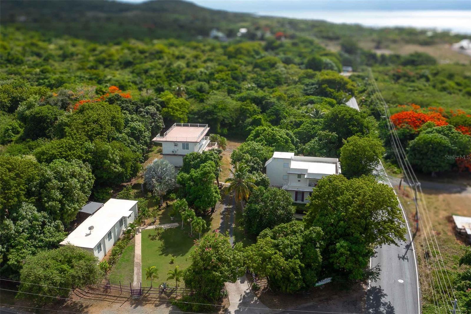 Discover a rare investment opportunity on Vieques Island with the Enchanted Garden Inn, an income-generating, multi-unit property set amidst lush tropical landscaping in the desirable Martineau neighborhood. Just minutes from the island’s top attractions, including the Bioluminescent Bay, world-class beaches, and historic Spanish Fort. This versatile estate has a strong rental history and offers both short-term and long-term income potential.
The property includes three distinct buildings totaling 15 bedrooms and is ideal for those seeking a profitable guesthouse, a multi-unit rental, or a personal retreat with business upside.
BUILDING 1 – THE CASITA
This single-level residence is currently used as the owner’s private quarters. It features a king bedroom, sunken living room, full kitchen with stainless appliances, modern bath, walk-in closet with washer/dryer, private office, and stylish finishes throughout. With 10-ft ceilings and A/C, it’s both elegant and comfortable.
BUILDING 2 – STUDIOS & PENTHOUSE
This 3-story structure includes 7 fully equipped studios (each with kitchenette, full bath, A/C) and a top-floor penthouse. The penthouse spans the entire level with 10-ft ceilings, ocean views, a king suite, spa-style bathroom, full kitchen, dining room, and private balcony.
BUILDING 3 – TWO-STORY HOUSE
The first level features 2 bedrooms, 1 bath, and an open kitchen/living space. The upper level offers 4 bedrooms, 2 baths, a full kitchen, and ample entertaining space. Both units have access to rooftop decks with panoramic views. Use as a large home or two separate rentals.
The Grounds
A true Caribbean oasis, the gardens are alive with mango, papaya, banana, guava, dragon fruit, and blooming tropical flora. Meandering paths, a tranquil water feature, and shaded sitting areas create a sensory escape for guests and residents alike.
Prime Location
Close to Gallito Beach, the W Resort, and the western edge of the Vieques Wildlife Refuge. The airport and ferry are within easy reach, as is the charming town of Isabel Segunda.
Investment Ready
Vieques continues to see strong tourism and rental demand. Whether your vision is hospitality, long-term rental, or a hybrid, Enchanted Garden offers flexibility, income, and beauty in equal measure.
This is one of Vieques’ premier investment properties. Don’t miss the opportunity to own a proven performer in paradise.