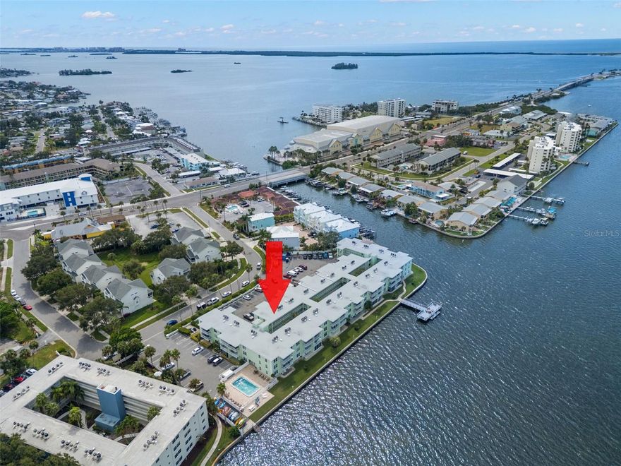 TURNKEY! Updated 2 Bedroom, 2 Bath Waterfront Condo in Dolphin Pointe, Dunedin. Discover your piece of paradise in the sought-after waterfront community of Dolphin Pointe, ideally located on the Dunedin Causeway just minutes from Honeymoon Island State Park. This updated 2-bedroom, 2-bath condo offers the perfect blend of comfort, convenience, and coastal living or utilize it as an income producing Monthly Vacation Rental as the current owners do. Inside you’ll find a split floor plan with a spacious primary suite featuring a king-size bed, walk-in closet, en-suite bath with tub, and its own TV. The guest bedroom offers a full-size bed, large walk-in closet, and easy access to a second full bath. The living area is light, bright, and decorated in a breezy beach theme, complete with a sofa that includes a pull-out bed, making this home truly move-in ready. Vinyl Planking throughout the Condo, except for Tile in the Primary Bathroom. Step outside to your private balcony to enjoy the fresh air and views of this waterfront community with a peek-a-boo view of the Water. Community Amenities include Heated swimming pool, Private fishing pier and dock with stunning sunset views, Kayak launch, Outdoor gazebo with grilling stations, Recreation room and picnic areas overlooking the water. Dolphin Pointe is walkable to restaurants, grocery stores, shopping, and the Pinellas Trail. Only a short bike ride or drive brings you to Downtown Dunedin, known for its vibrant dining, entertainment, farmer’s market, and boutique shops. This unbeatable location offers both everyday convenience and a true Florida lifestyle. One assigned parking space #49, and additional guest parking available. Community Locked Storage area included. Kayak storage rack spaces available for Rent. Community Laundry on the 1st Floor. Cable & Wi-Fi included with Maintenance fees. AC replaced August 2022. The Owners are selling the Unit furnished and activily rents the unit monthly with lucrative revenue. Minimum of one month rental. Milestone Inspection has been completed. Roof Replaced in 2024, exterior being painted before the end of 2025. Special Assessments have been paid.