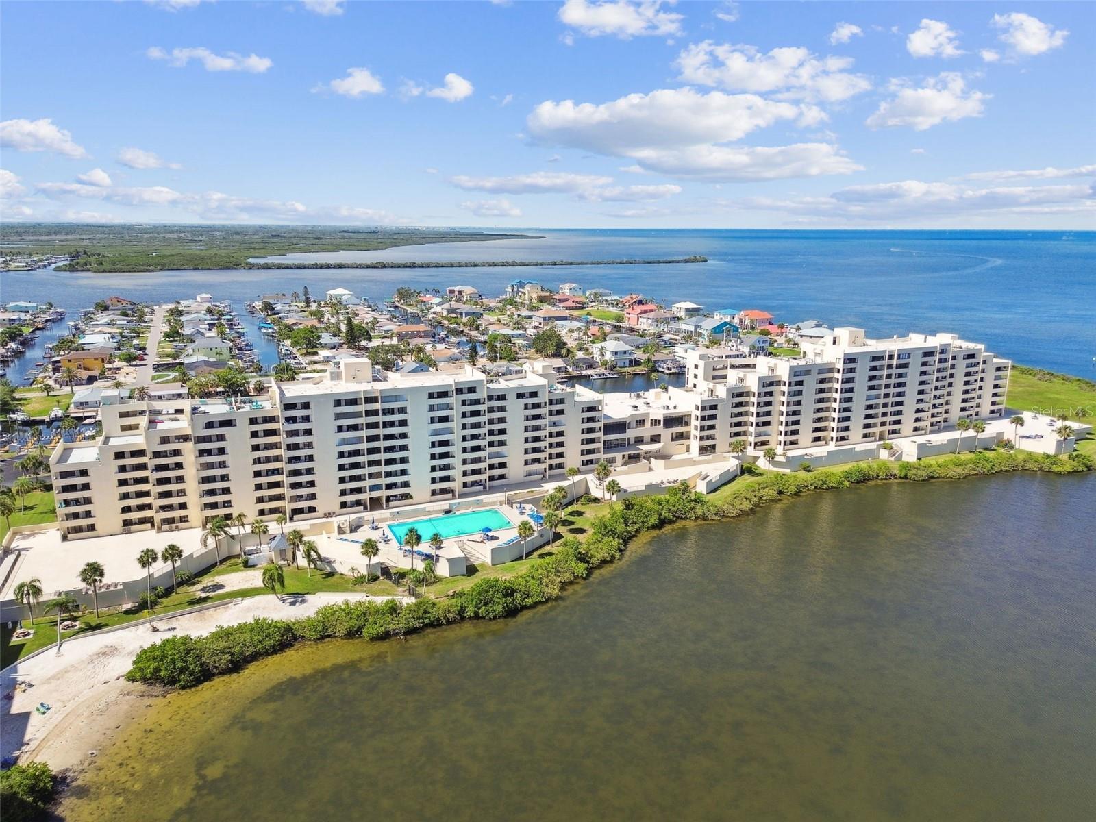 Welcome to Paradise!!
Enjoy watching dolphins, manatees and birds frolic in the lagoon from your living room, bedroom and back balcony which also offers SPECTACULAR SUNSET VIEWS in this furnished 2nd floor unit located in Building #3. This unit has an ASSIGNED PARKING space in the covered garage and assigned extra-large storage cage. Hurricane shutters, A/C is 2016, new hot water heater, built in bookshelves in the living area.
The primary bedroom offers ample storage featuring a custom built in wall unit, desk and under bed storage. The secondary bedroom comes equipped with a custom murphy bed and built in storage. The secondary bathroom offers IN UNIT washer and dryer, fold down ironing board and a soaking tub. This spectacular unit is turn-key and ready to become your home!
Association fee includes water, trash, Spectrum cable TV and in-unit WiFi. Community Features: 24hr Guard, Heated HUGE SALTWATER pool, clubhouse, game room and fitness center, tennis/pickleball courts, private beach, lagoon, BBQ areas & nature trail! Access to community workshop with drill press, table saw, benches, etc. Gulf Island Beach & Tennis Club is truly the hidden GEM of Pasco County, this community offers residents and owners an active waterfront lifestyle.