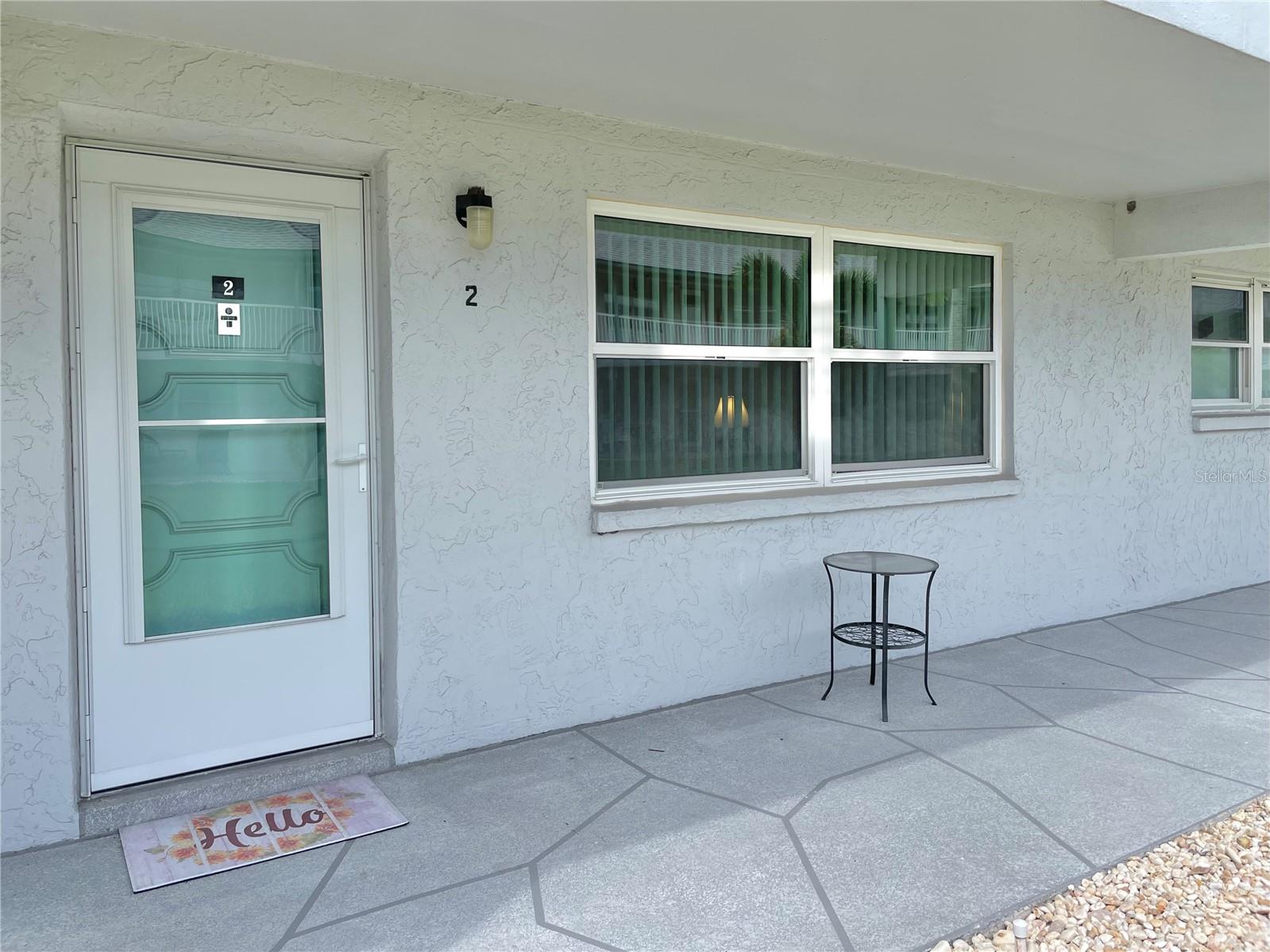 Welcome to this impeccably maintained first-floor, one-bedroom, one-bath condo with a delightful Florida room in the desirable Paradise Shores community. The updated galley kitchen features custom cabinets with pullouts, granite countertops, and a large pantry. The cozy Florida room has a spacious storage closet. The bedroom opens directly to the Florida room and has a walk-in closet. The beautifully remodeled bathroom includes a walk-in shower, modern vanity, custom lighting, and a linen closet in the hall. The living and dining area are in the "front of the home" which opens up to a sitting area and courtyard. Highlights include tile flooring throughout, updated storm windows, and new AC in 2024. Your covered carport is conveniently located just steps from your back door and right across the street from the heated swimming pool, tiki huts, and shuffleboard. This one-of-a-kind condo is offered fully furnished and turnkey, ready for you to move right in! It's affectionately known as "The Crab Condo" for the small fiddler crab glued on the wall in the hallway which has been there since before these owners. The monthly HOA fee covers internet, cable TV, gas for cooking and hot water, building exterior, reserves, insurance, grounds maintenance, recreational facilities, roof, trash, sewer, and water. Enjoy maintenance-free living in Paradise Shores. Ideally located just minutes from St. Pete’s vibrant downtown, pristine beaches, and a quick commute to the airport, this condo is perfect as a full-time home or vacation getaway. Move in and make it yours today! All measurements approximate.