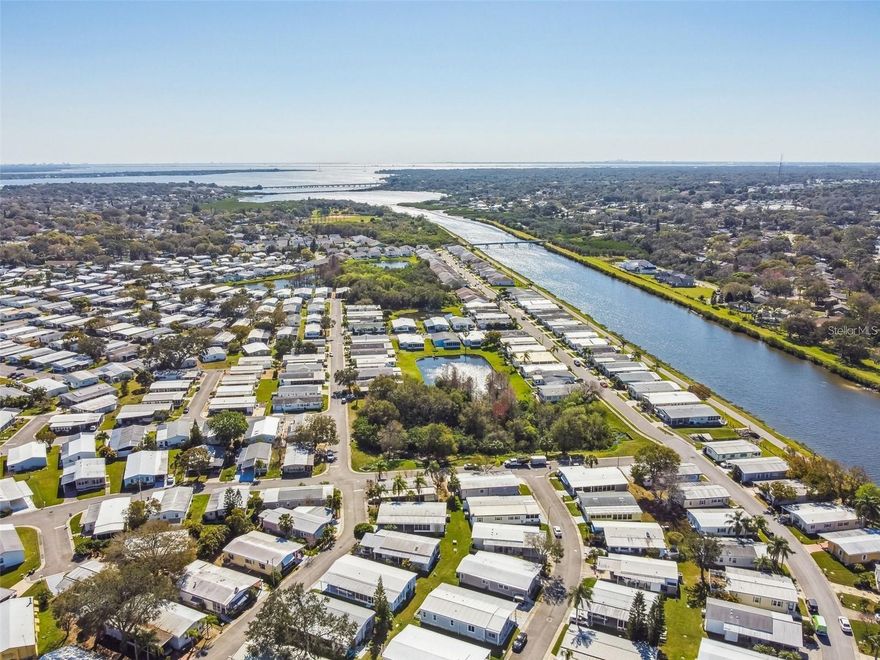 Welcome to Gull-Aire Village, a 55+  PET-Friendly and Golf Cart Friendly community in the Heart of Oldsmar! Gull-Aire Village is a Land-Owned community, meaning YOU OWN THE LAND! not just the home. A Very unique property with No rear neighbors. This home comes FULLY FURNISHED! and Features New Flooring(2025) New Water Heater(2025) Newer AC(2022) Newer Samsung Washer and Dryer(2024) This 2-bedroom, 2-bath home is situated on a serene canal view lot and offers the perfect blend of comfort, convenience, and Florida charm. Inside, you'll find a bright and spacious living area, a functional kitchen with plenty of cabinet space, and a screened Florida room where you can relax and enjoy peaceful water views. Split bedroom plan, the primary bedroom features an En-Suite bath, and one additional bedroom for guests, hobbies, or a home office. Beautifully landscaped. Air conditioned Florida room that is not included in the square footage 14 x15. Additional glass enclosed porch on rear of home 10 x14. Good sized utility too. 
With a Low-cost monthly HOA fee of Only $60 a month, it’s an affordable option for those seeking an active lifestyle. Community amenities include a Heated Pool, Spa, Active Clubhouse with a Library and Pool Table, Shuffleboard courts, Bocce ball court and a calendar of Social Events. Just cross the street and there are wonderful Restaurants, Shopping, and a movie theater! You can walk to AMC theatres, Beall’s, Marshall’s, Dollar Store and Restaurants. Just minutes to Westfield Mall, Target, a Super Walmart, Publix and Countryside Hospital. A walking/running/biking trail is located adjacent to Canal Way, which takes you directly to picturesque Sheffield Park, which is a lovely place with trails to walk, play disc golf, PICKLEBALL, or go to the Dog Park. There is also a playground for the grandkids. You can walk along the path of the Tarpon outfall canal, on the west edge of Gull-Aire Village, and enjoy all the Florida wildlife, including the occasional Manatee sighting. Very Close to Dunedin and Safety Harbor! Less than 30mins to Tampa International Airport. Only 20 minutes to Honeymoon Island Beach and Caladesi State Parks. Come Enjoy the Florida Life-Style with this Low Maintenance home!!